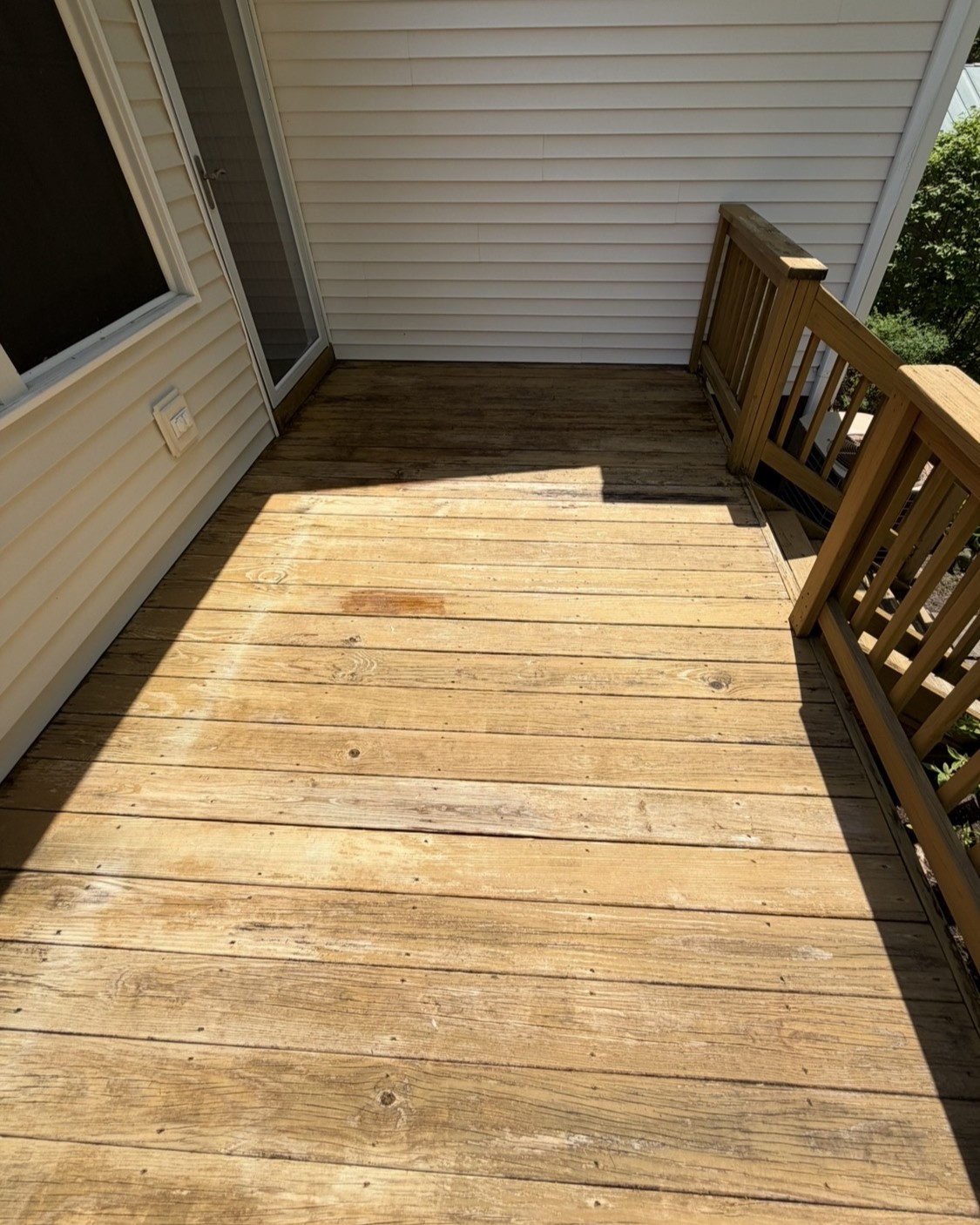 Wood deck after professional cleaning and restoration by Thin Red Line Pressure Washing in Clifton Park, NY.