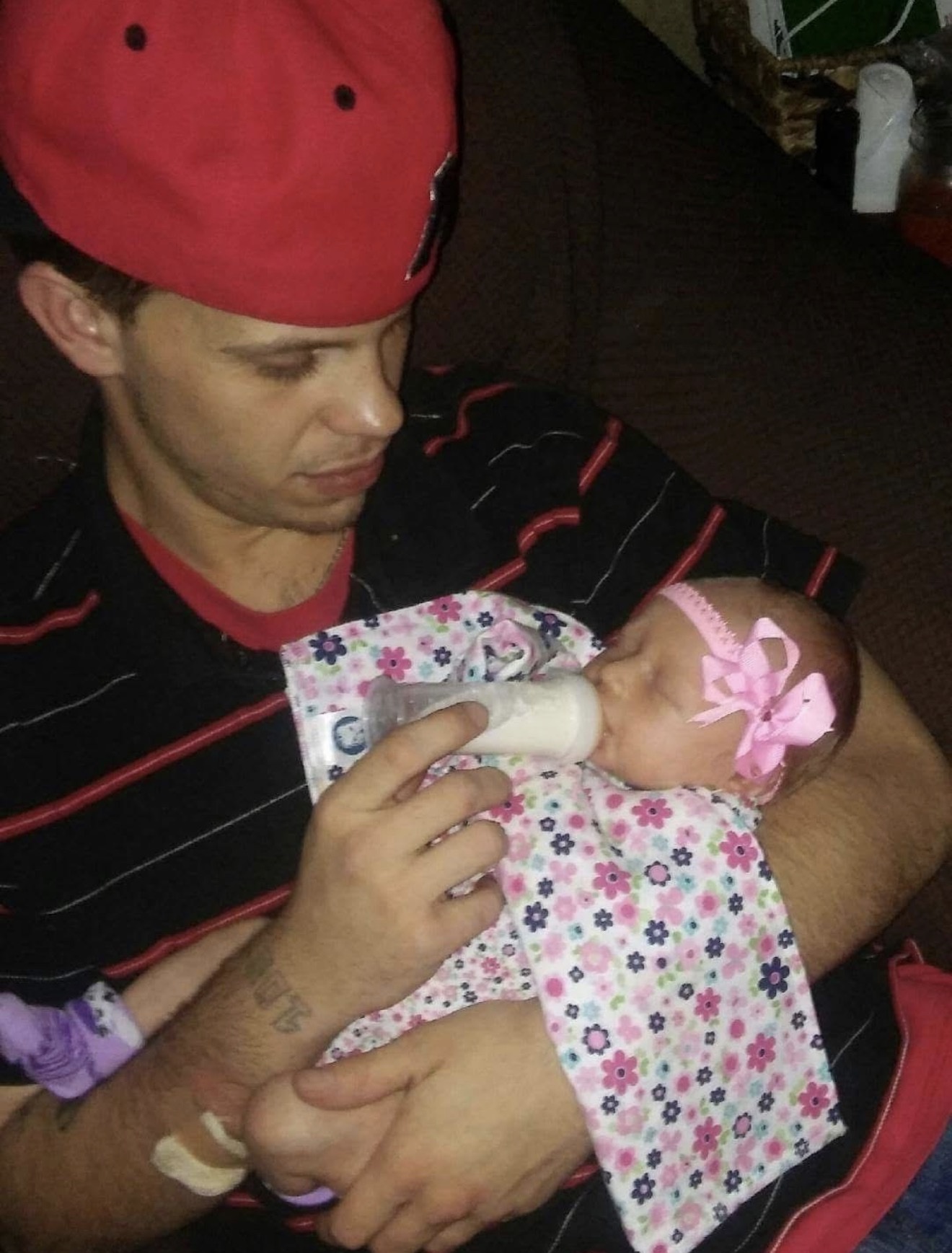 Austin bottle-feeding a newborn