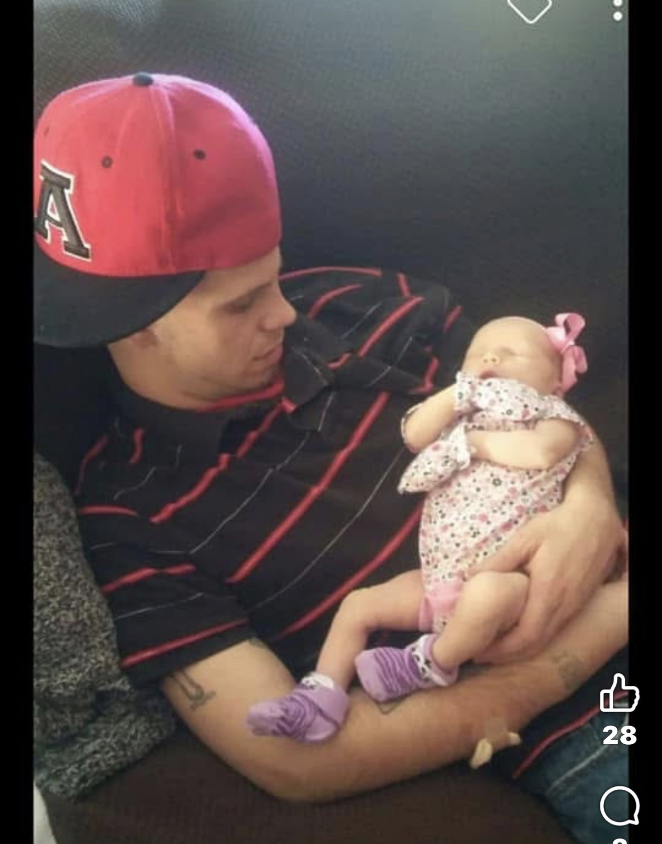Austin holding a newborn baby