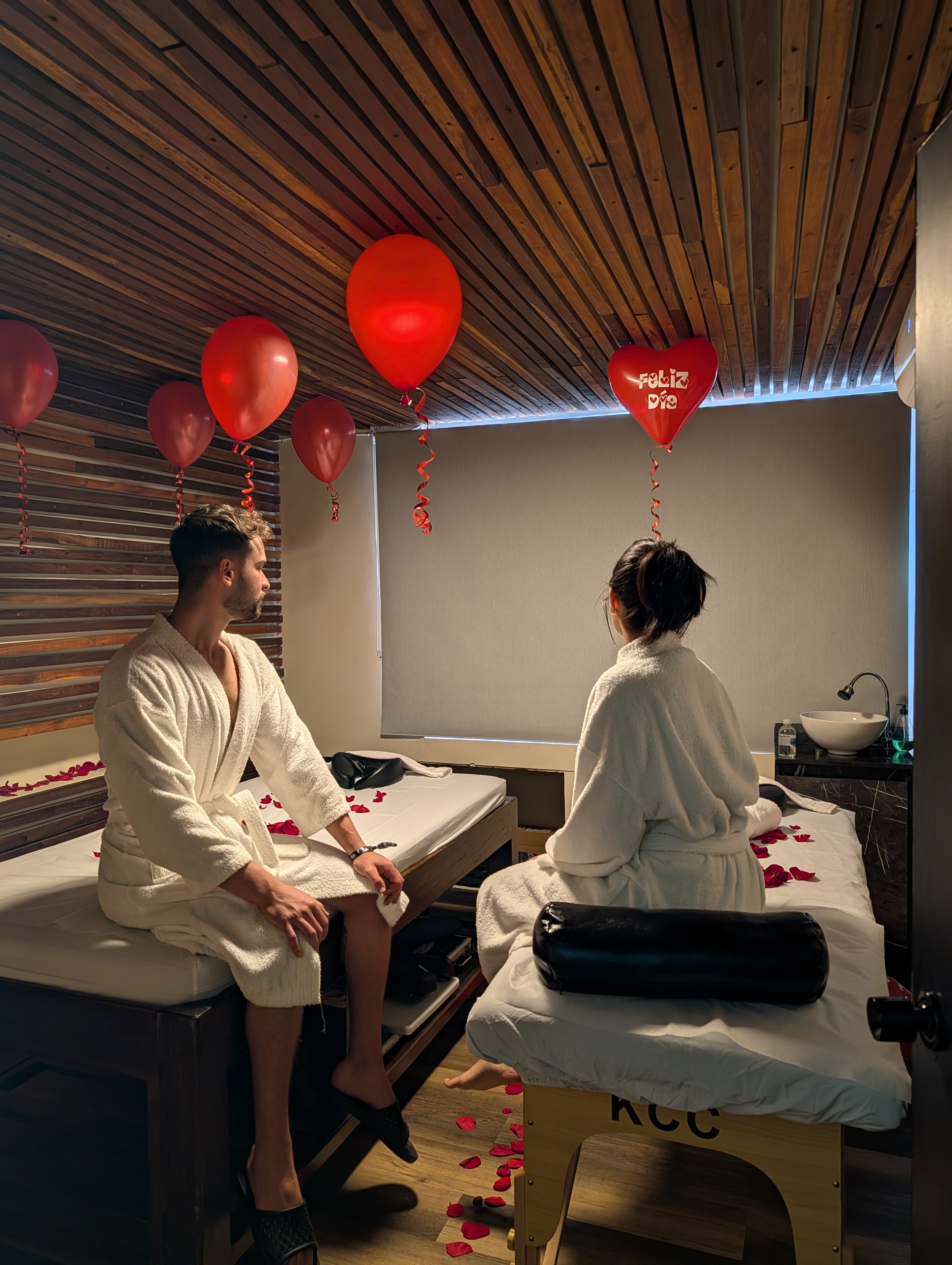 A couple side by side in robes in the CIMA couples suite — El Poblado, Medellín
