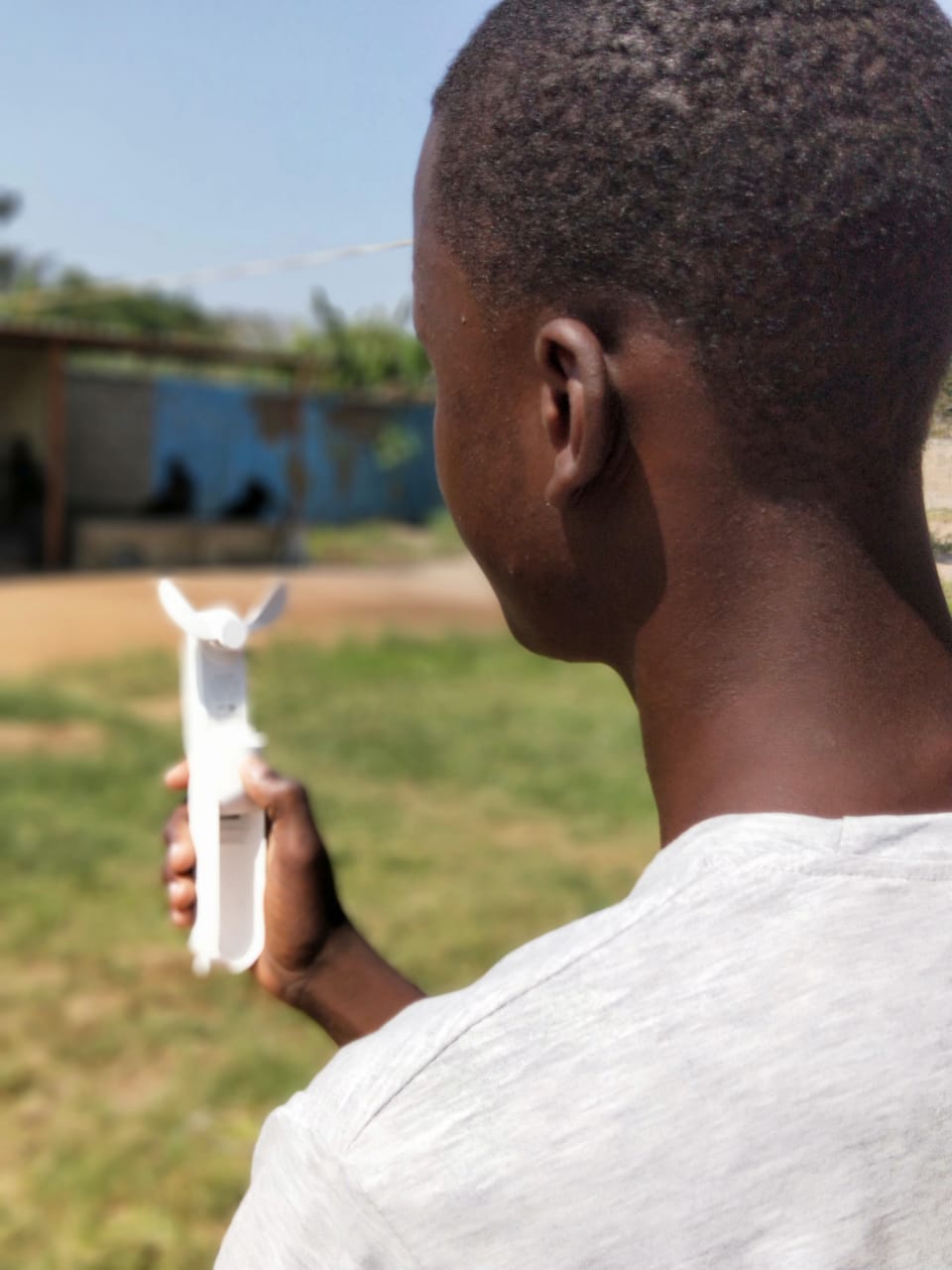 Nuno holding a rechargeable handheld fan at Beacon of Hope Africa in Mozambique Nuno holding a rechargeable handheld fan at Beacon of Hope Africa in Mozambique