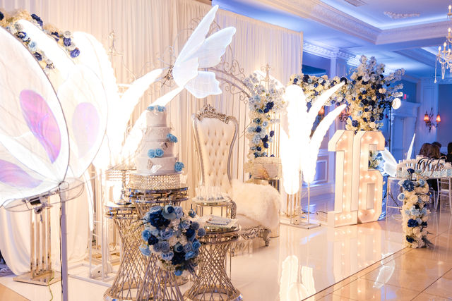 Quinceañera with silver butterfly wings, an illuminated 15 and throne chair by MJ Event Designs