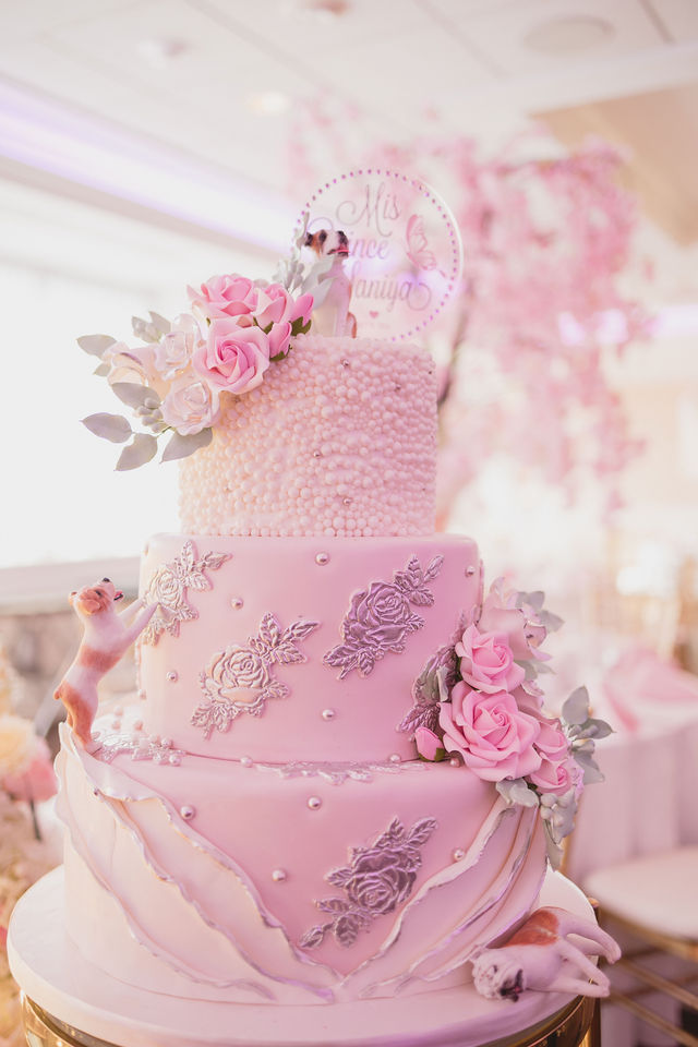 Pink three tier quinceañera cake with silver florals, pearls and dog figurines by MJ Event Designs