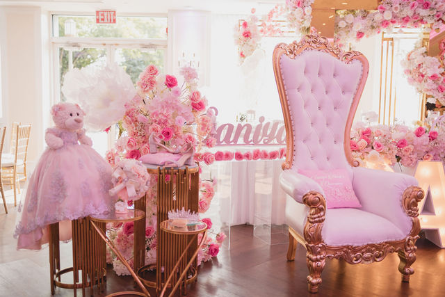 Baby shower with a pink rose centerpiece and pink and gold throne chair by MJ Event Designs