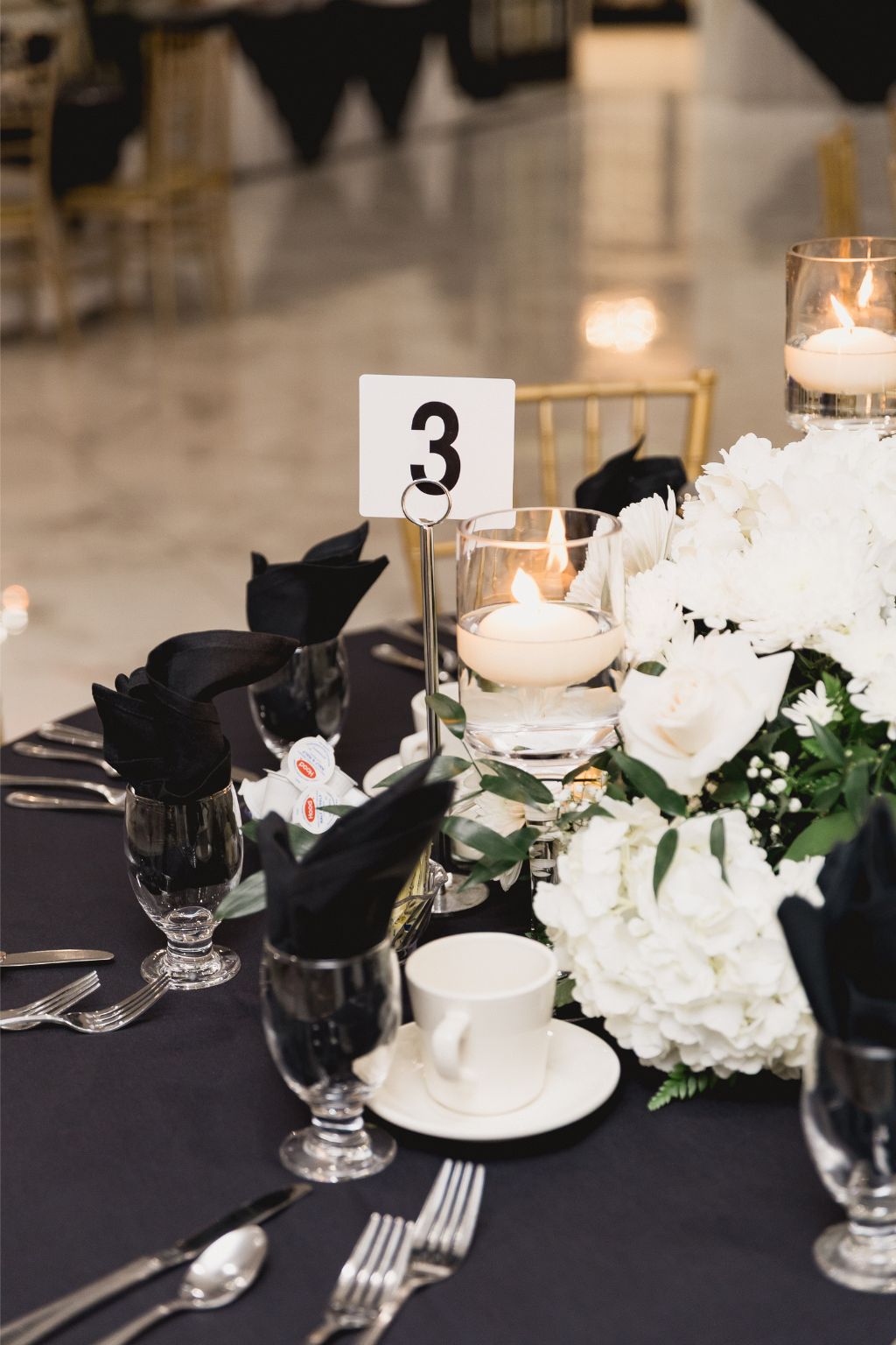 Graduation celebration with black and white roses and floating candles by MJ Event Designs