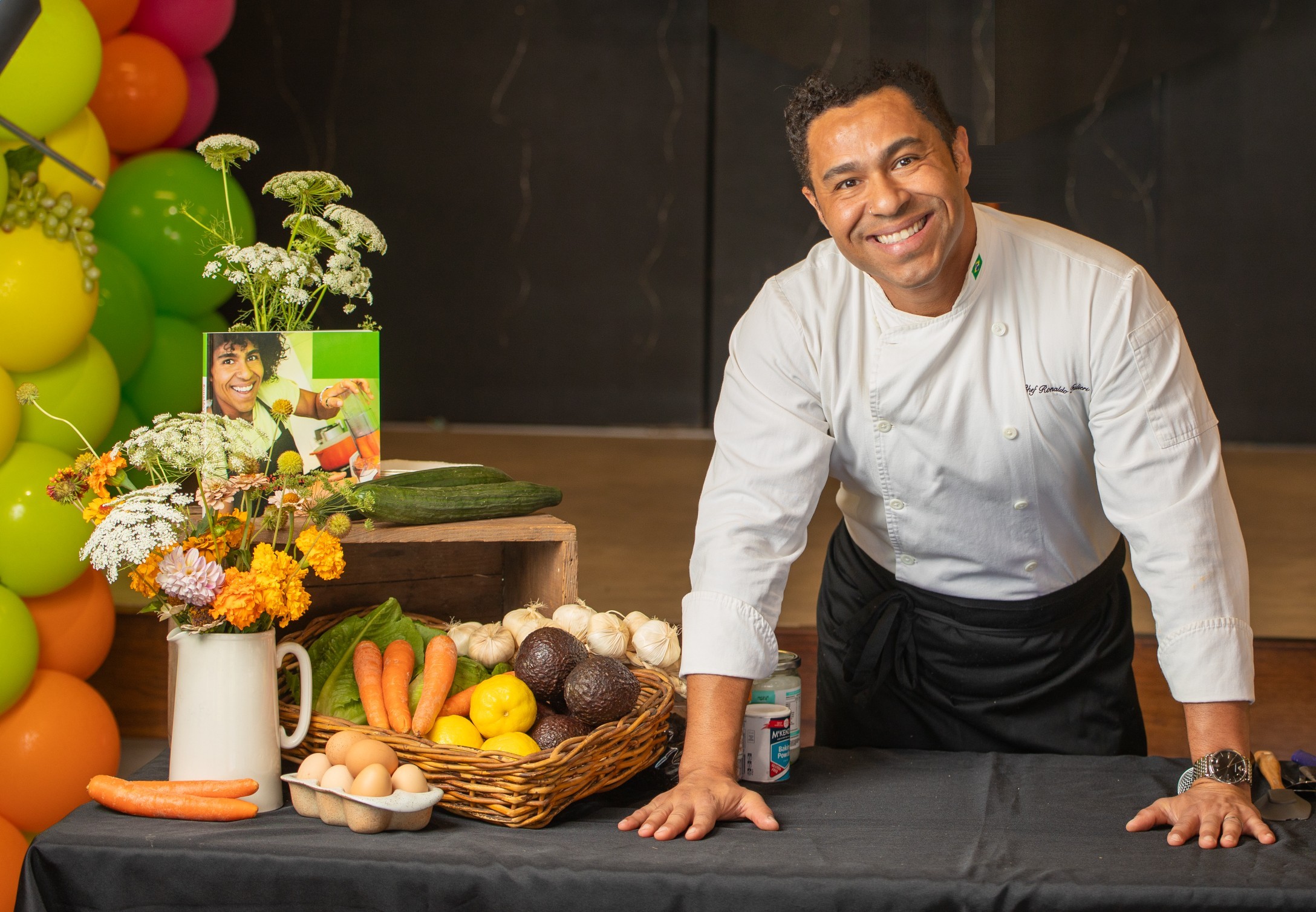 Ronaldo Fulieri in his chef uniform beside fresh ingredients