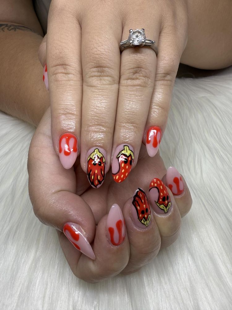 Almond nails with cartoon strawberries and red drip tips
