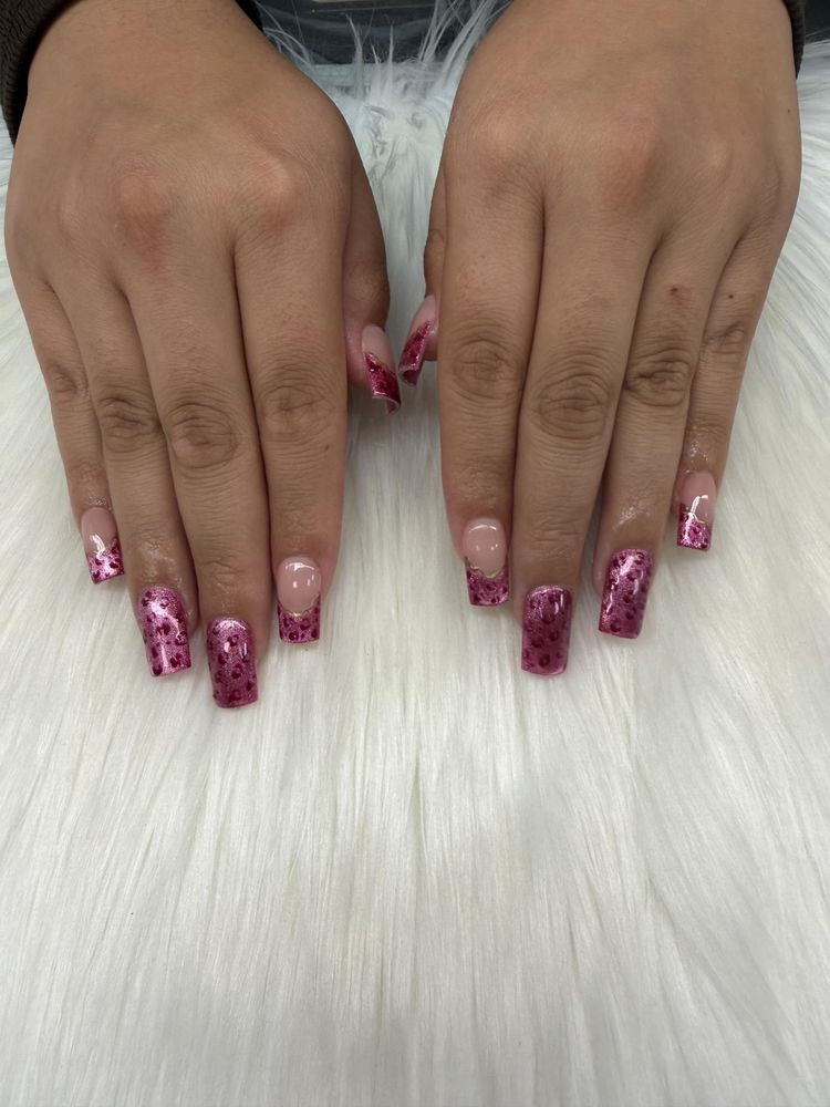 Square nails with pink glitter leopard print and gold-lined French tips