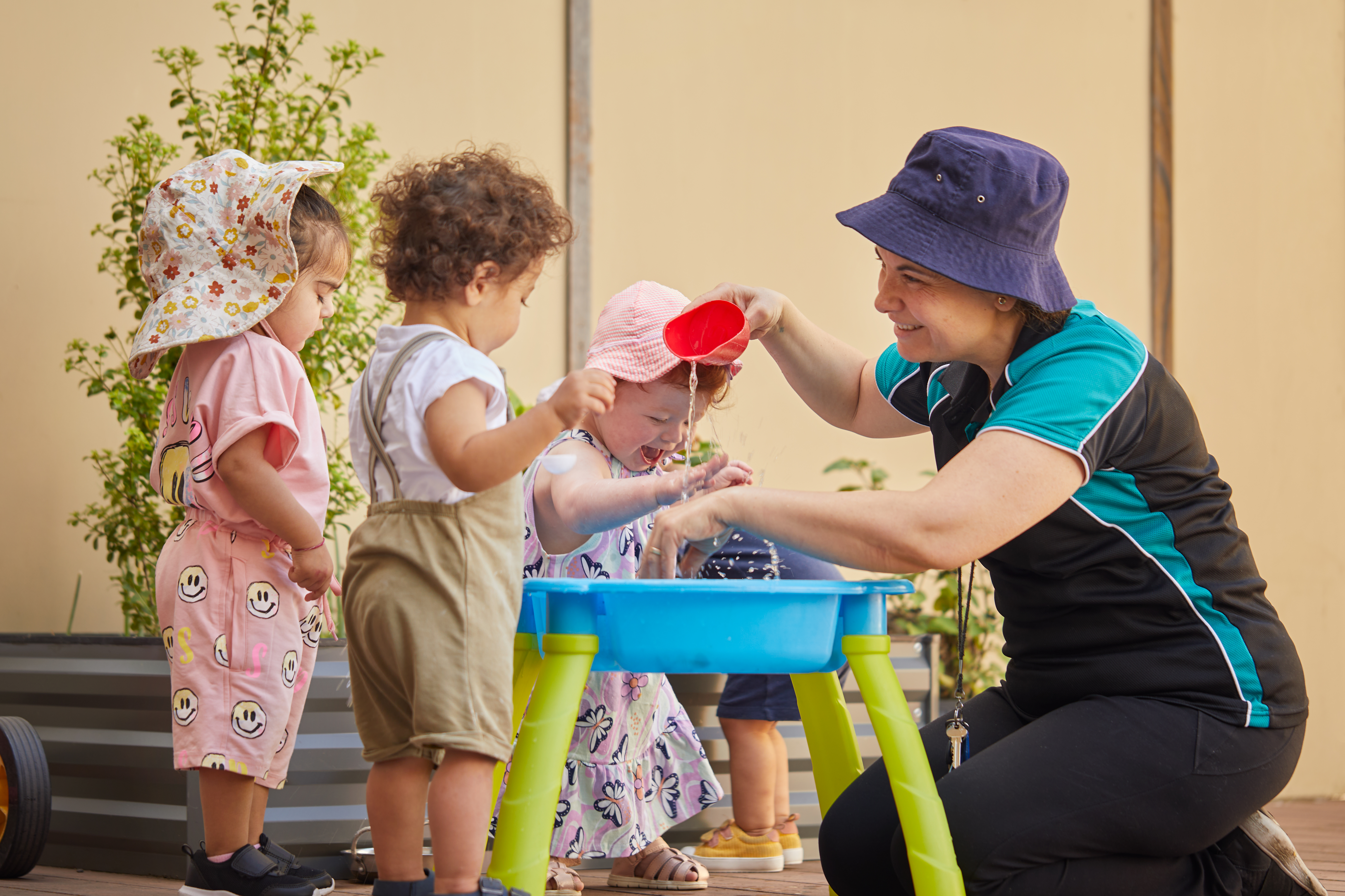 educators watch children do sensory play
