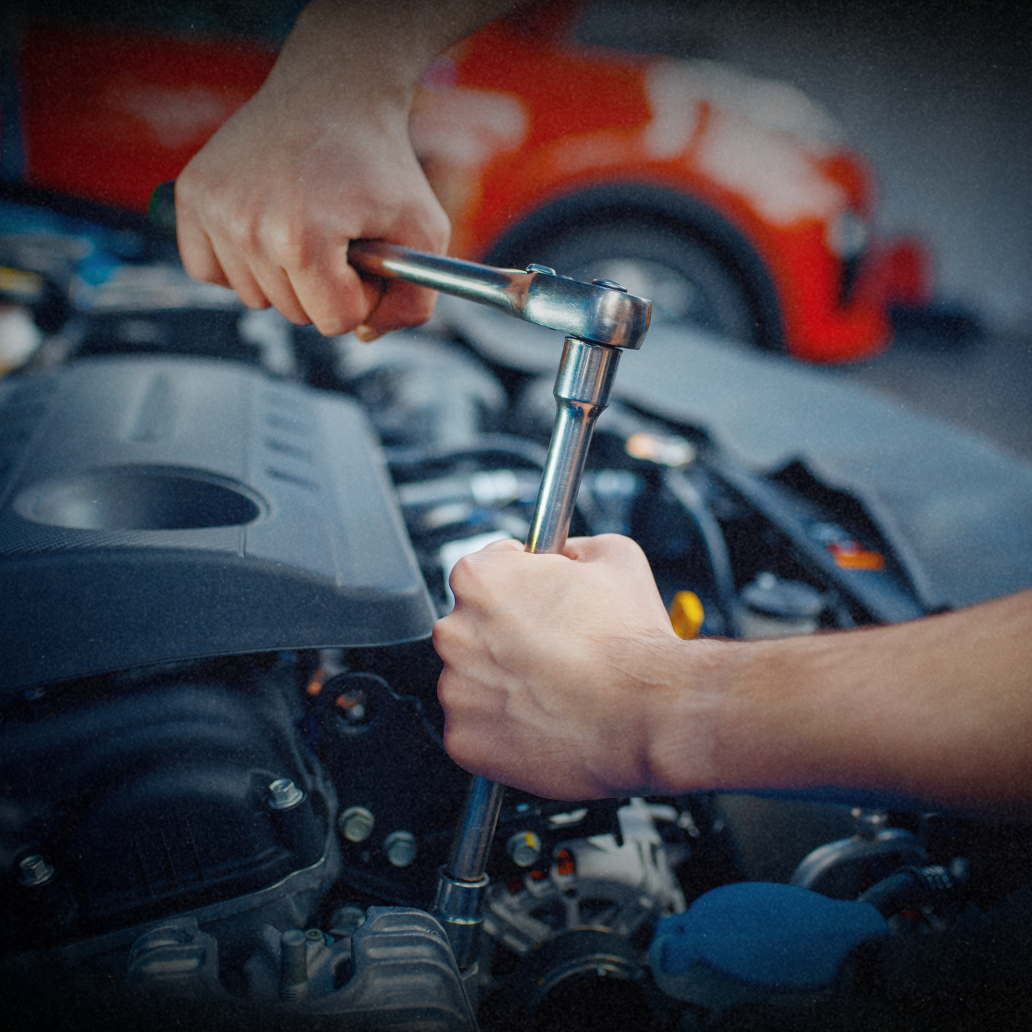 Mechanic inspecting car engine for transmission and drivetrain service