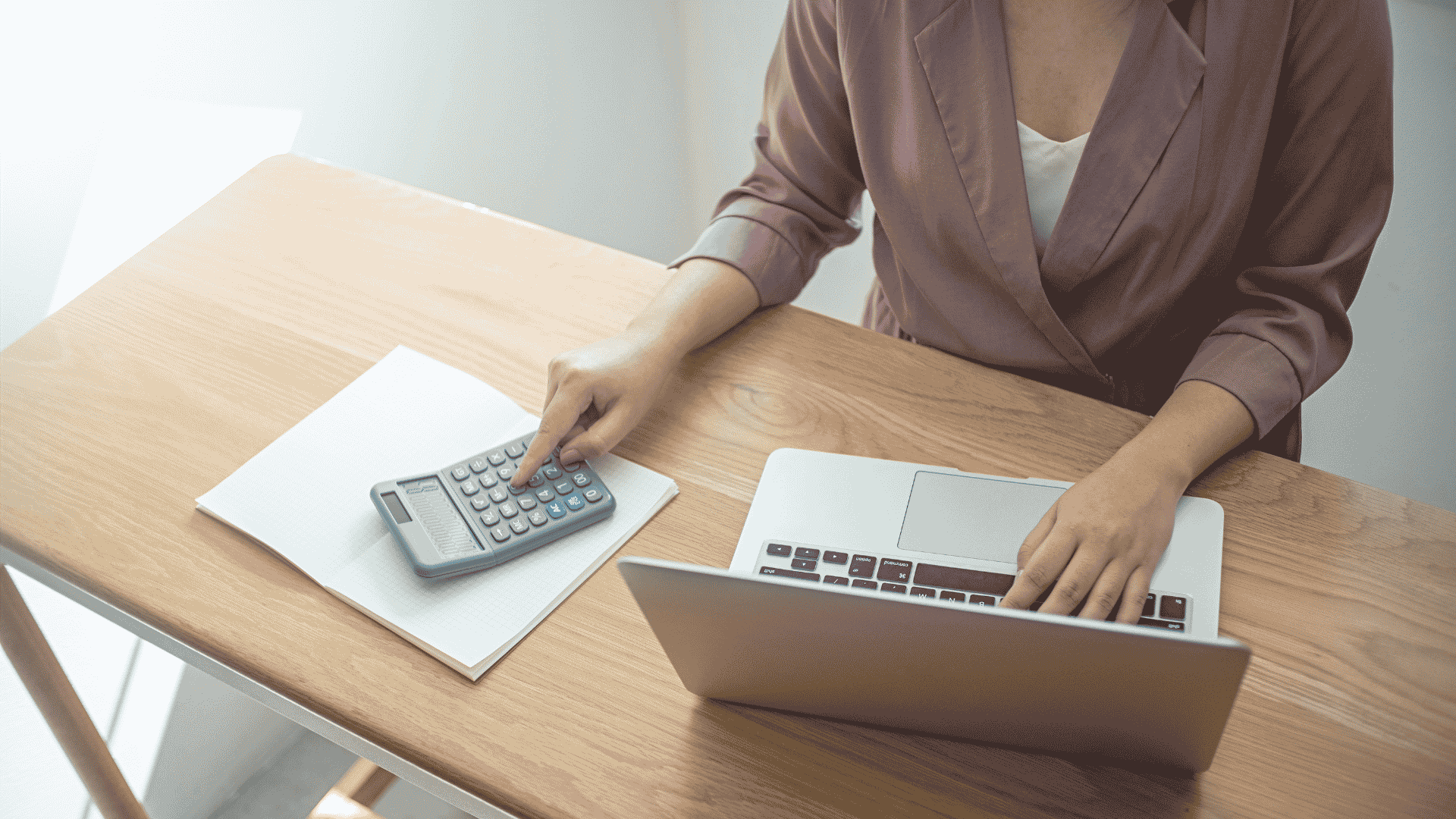 therapist reviewing nonprofit salary and revenue numbers at desk therapist reviewing nonprofit salary and revenue numbers at desk