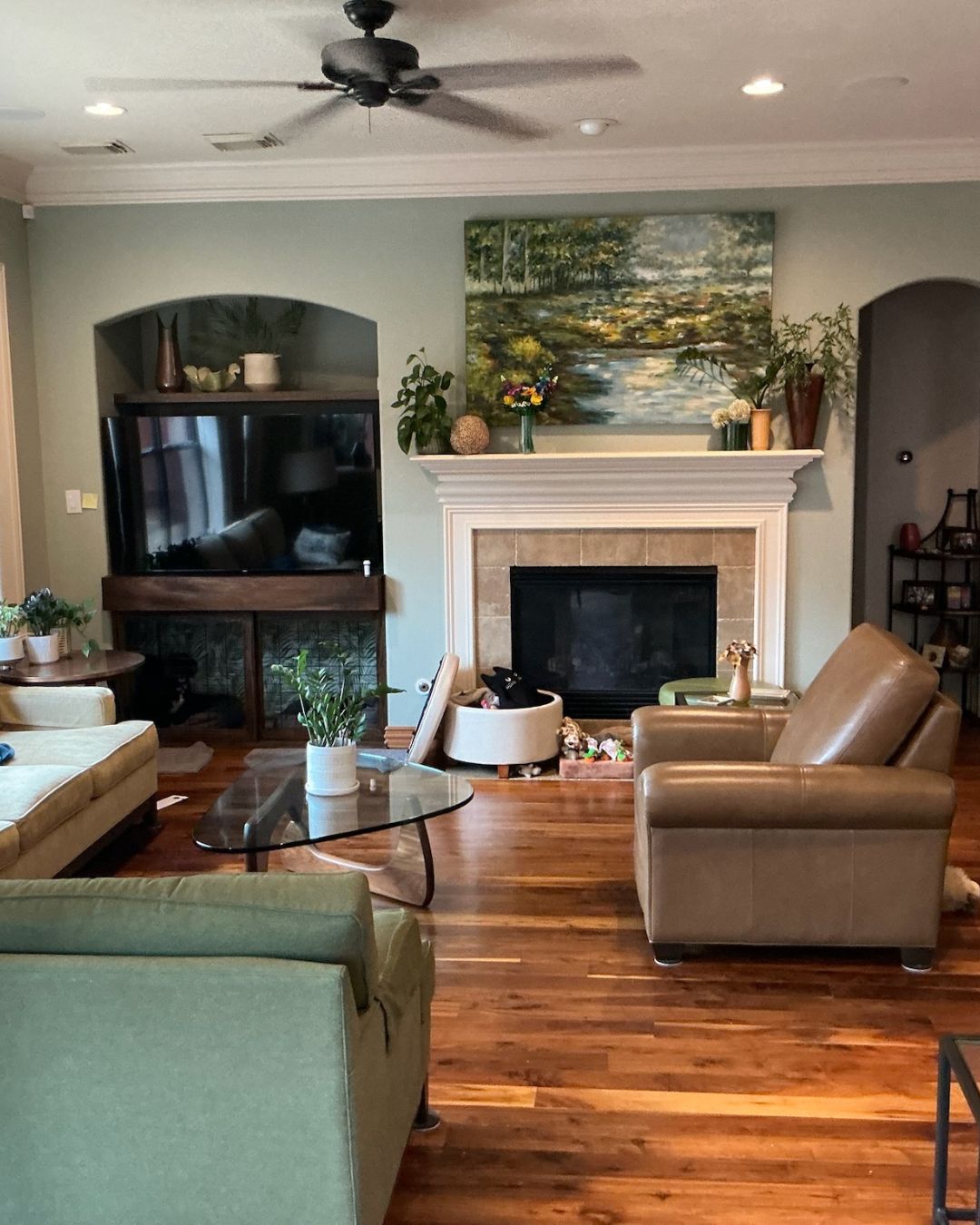 Professional drywall specialist applying an orange peel texture finish to a living room wall.