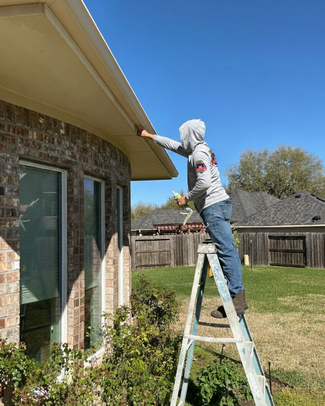 Painter caulking exterior fascia and soffit on Katy, TX home