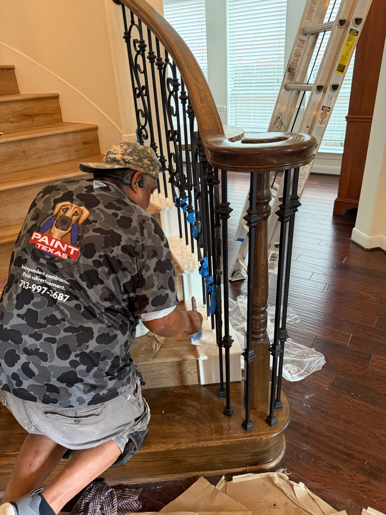 Professional painter from Paint Texas applying finish to interior trim in a luxury Katy, Texas home.