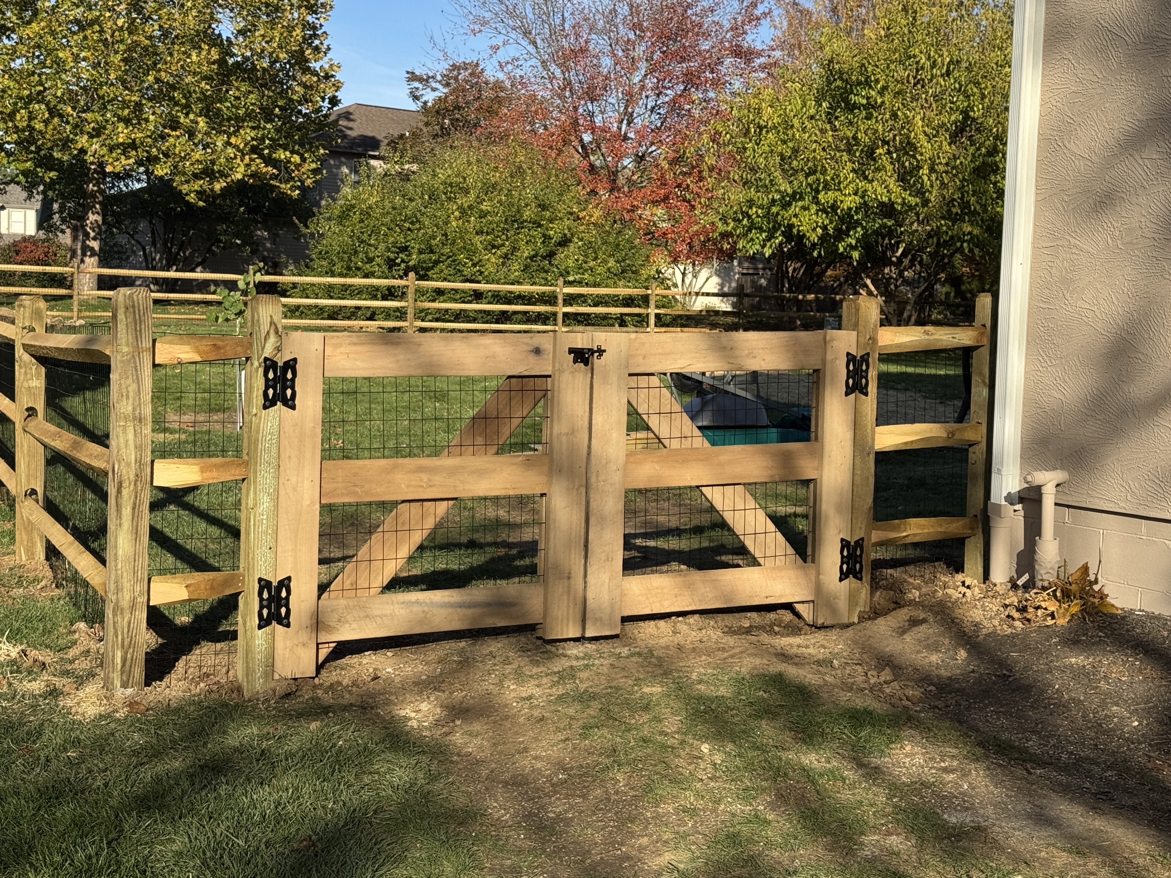 Double-driveway wood farm gate and post entry system in Marysville, OH.