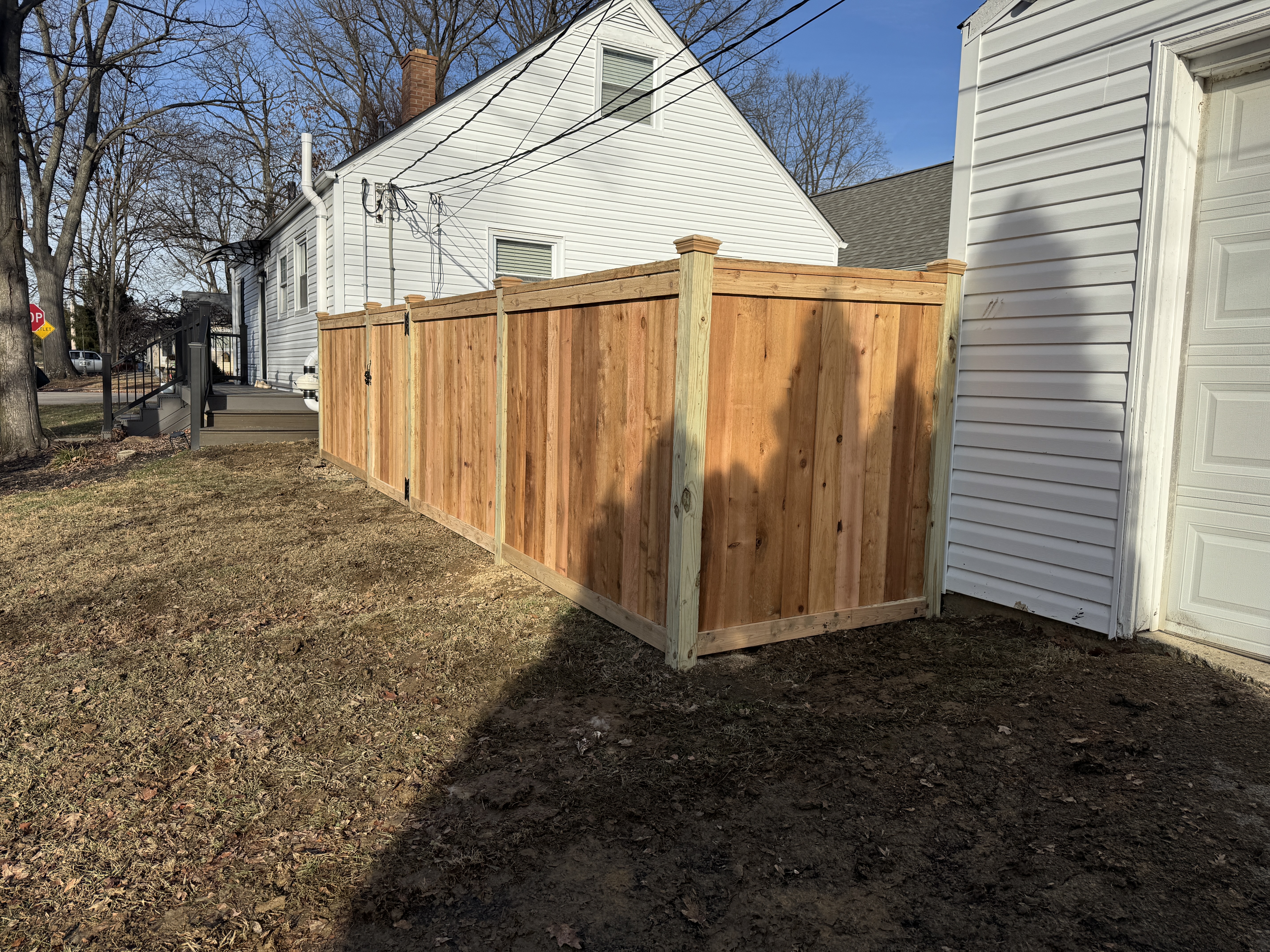 Classic flat-top wood privacy fence panel installation in Newark, OH.