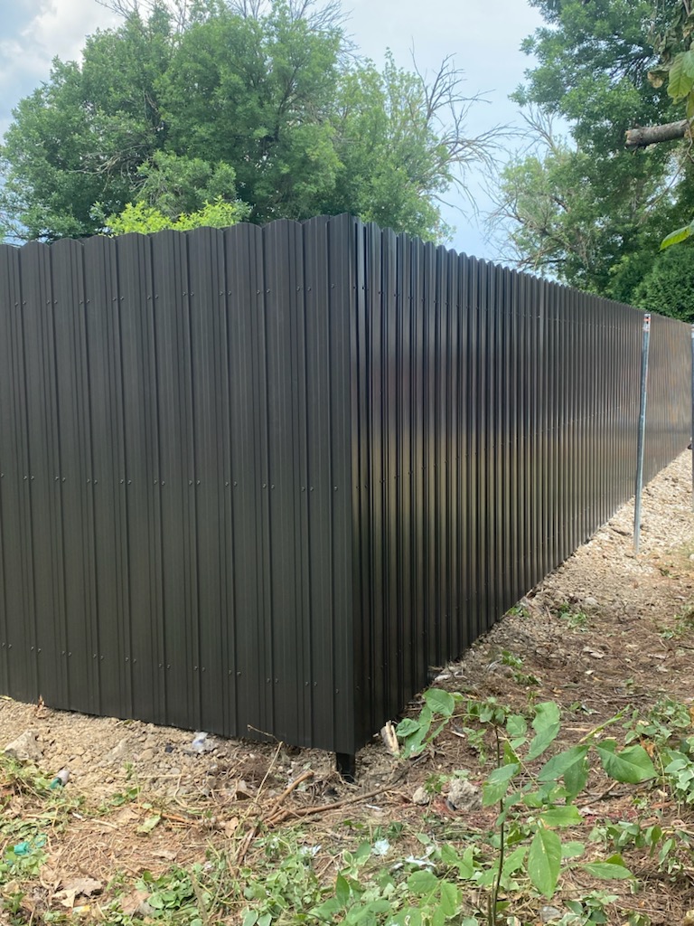 Stepped aluminum fencing installed perfectly on a sloped yard in Granville, OH.