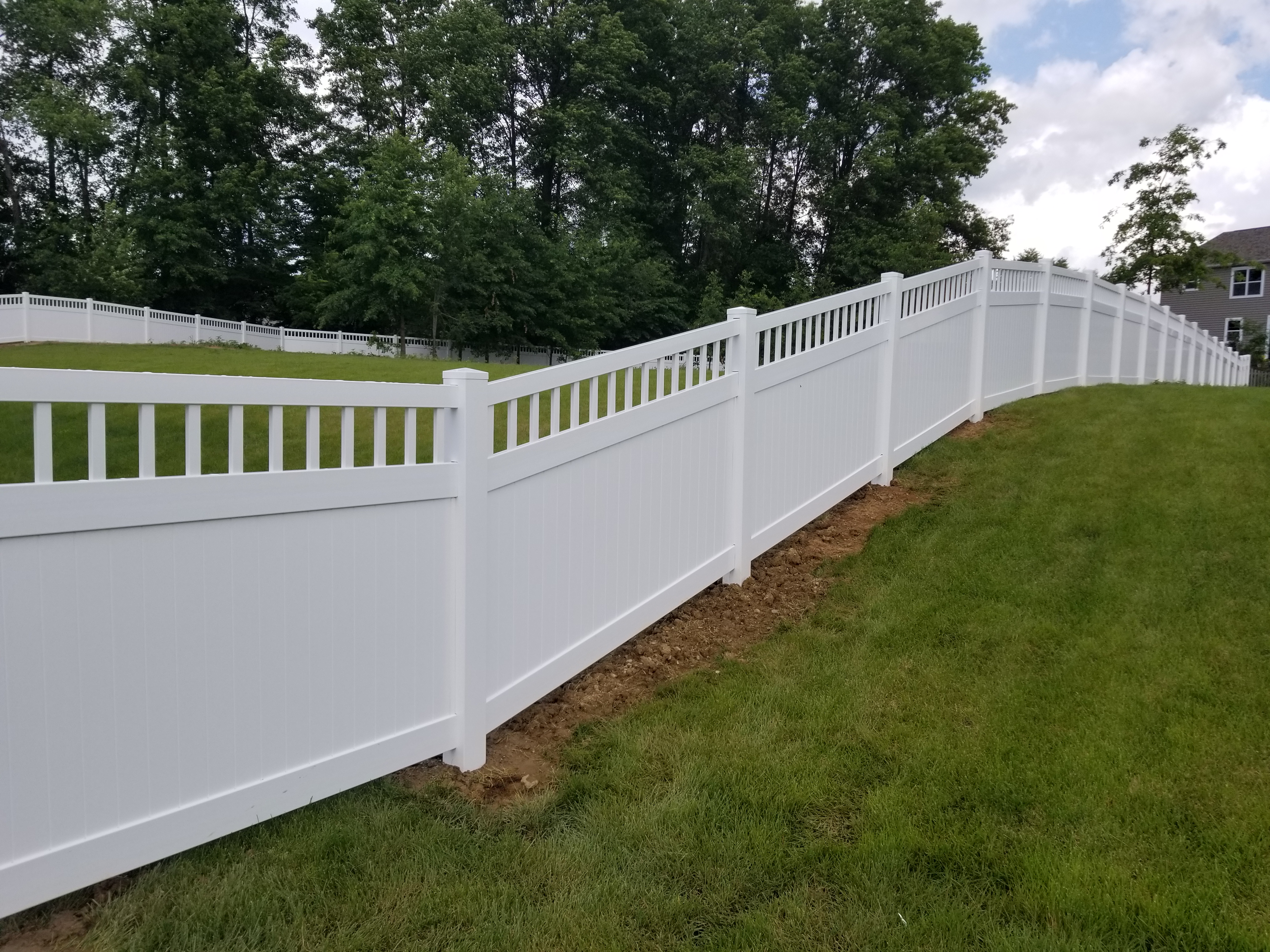 Two-tone vinyl privacy fence design installed in Newark, OH.
