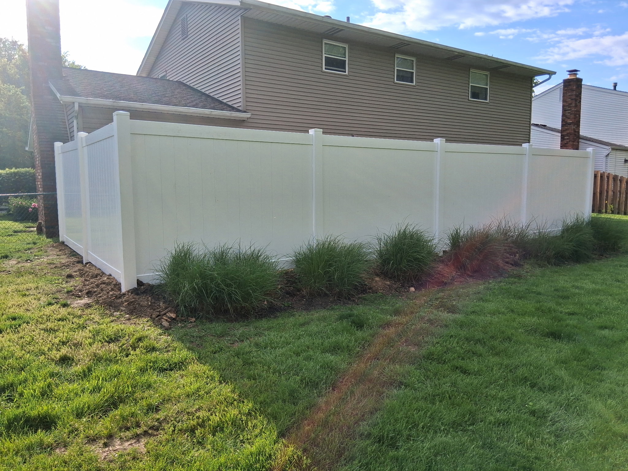 Tan vinyl privacy fence built for maximum residential security in Delaware, OH.