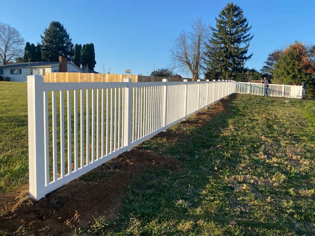 Tall white vinyl perimeter privacy fence in Worthington, OH.