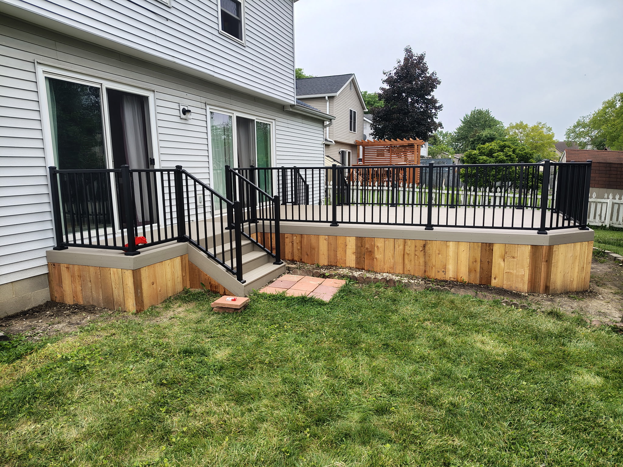 Custom treated wood deck and patio transition in Newark, OH.