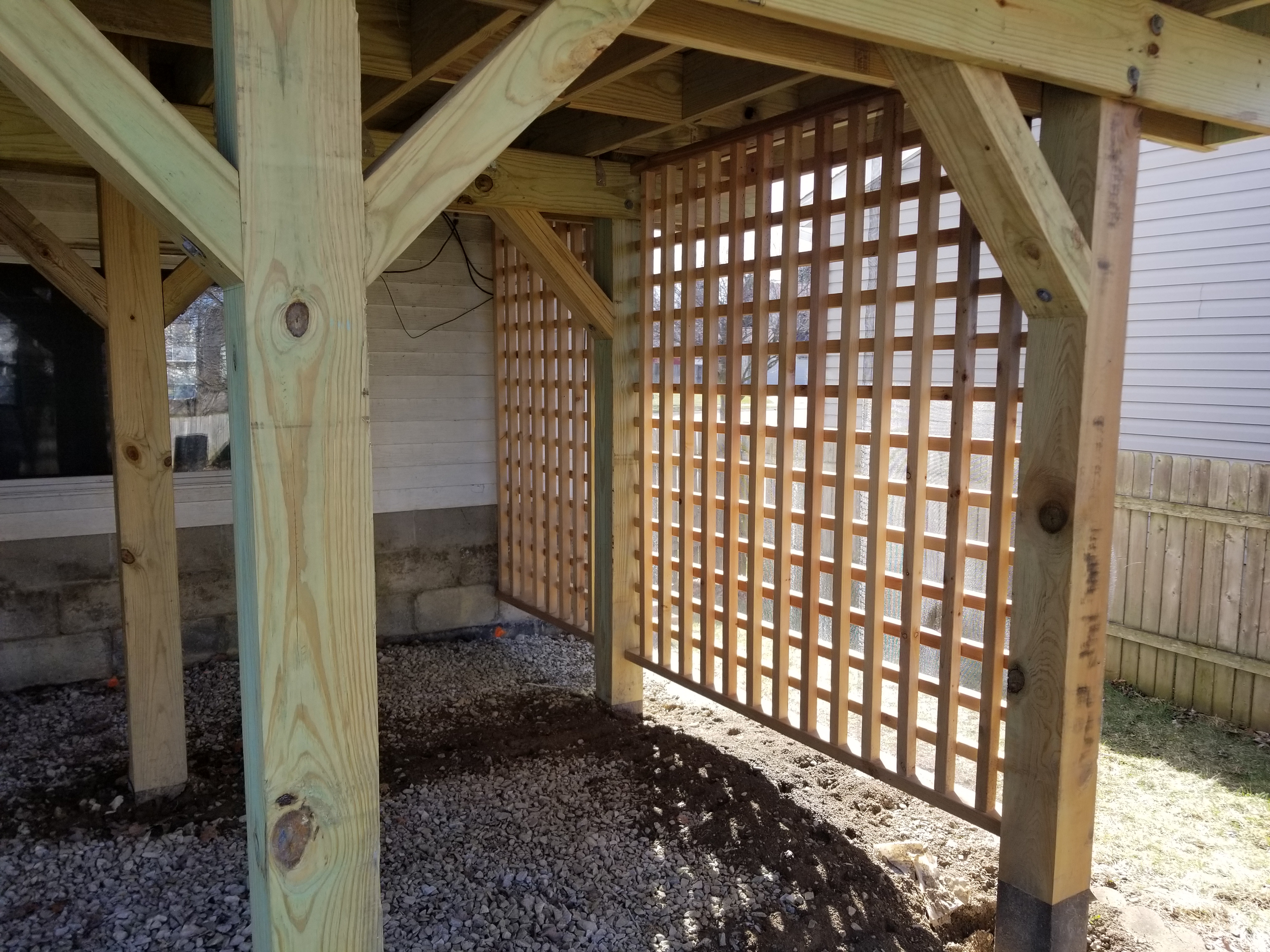 Outdoor living space protected by a custom wood patio cover in Grove City, OH.