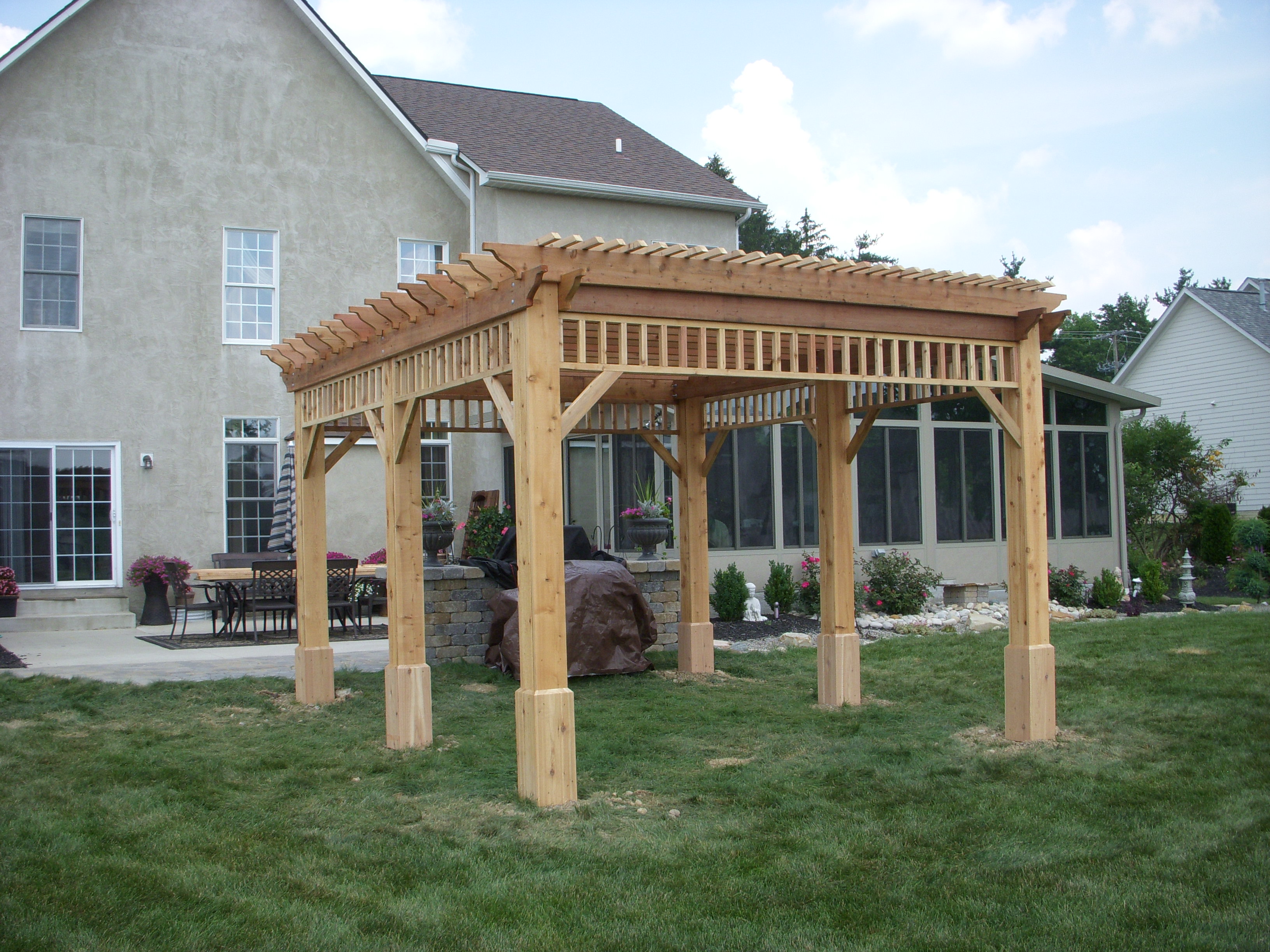 Custom outdoor wood pavilion covering a patio seating area in Lancaster, OH.