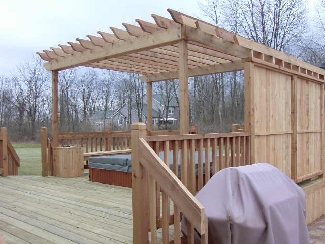 Backyard patio cover with sturdy wood beams and roofing in Columbus, OH.