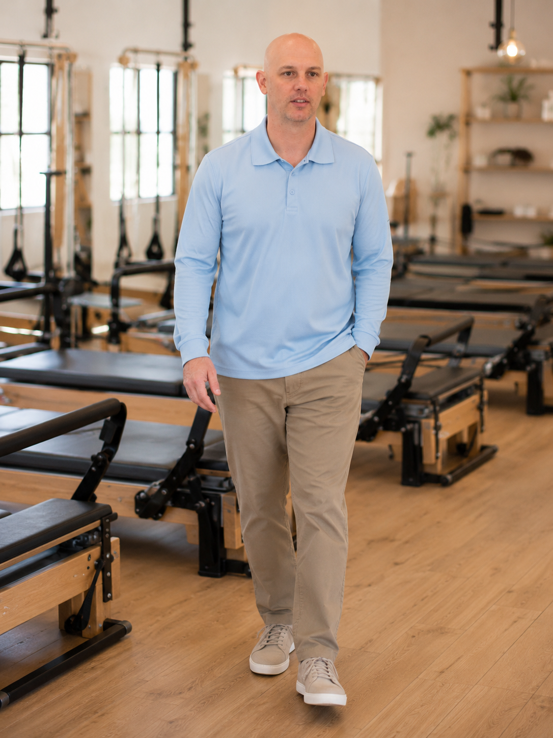 Paul Roch walking through a boutique Pilates studio
