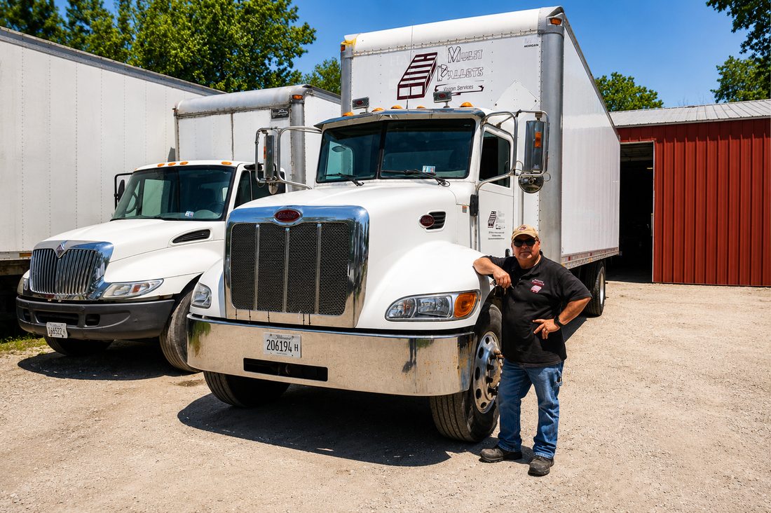 Oscar Hernandez, owner of Multi Pallets, standing beside the company truck in Waukegan, IL