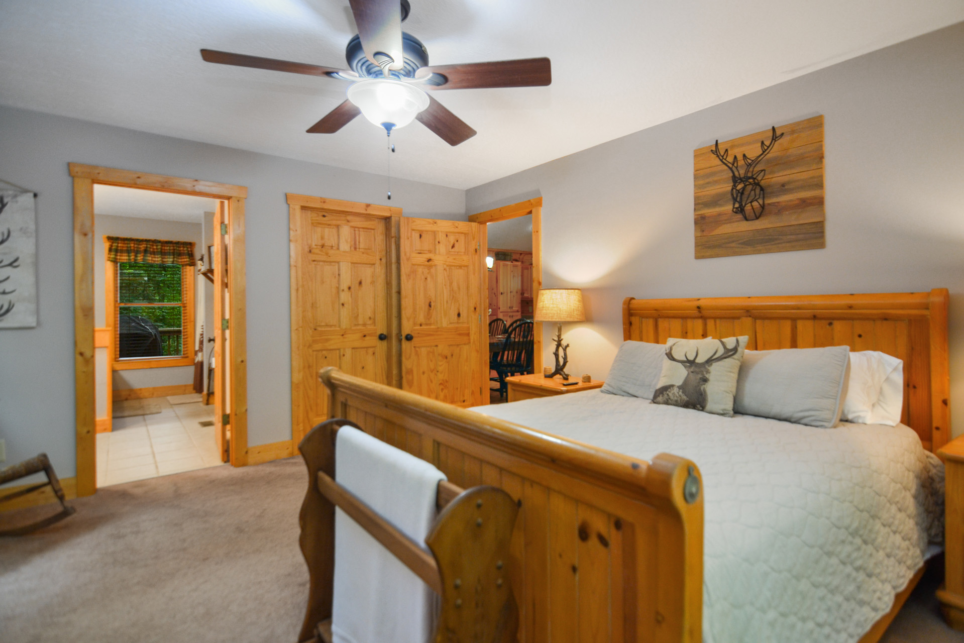 Master bedroom suite with plush linens and rustic timber frame