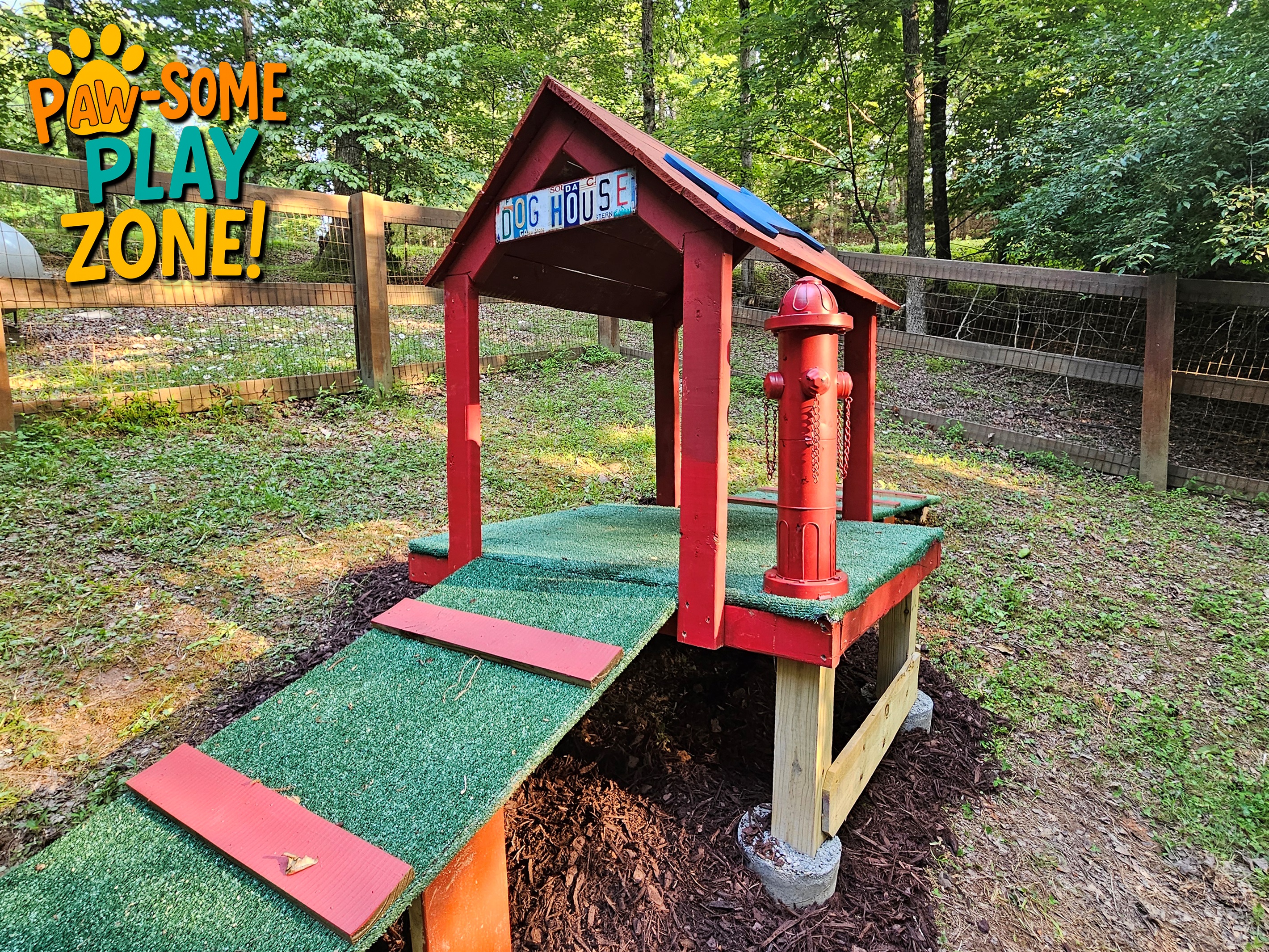 Fenced dog yard with dog house and ramp for pets