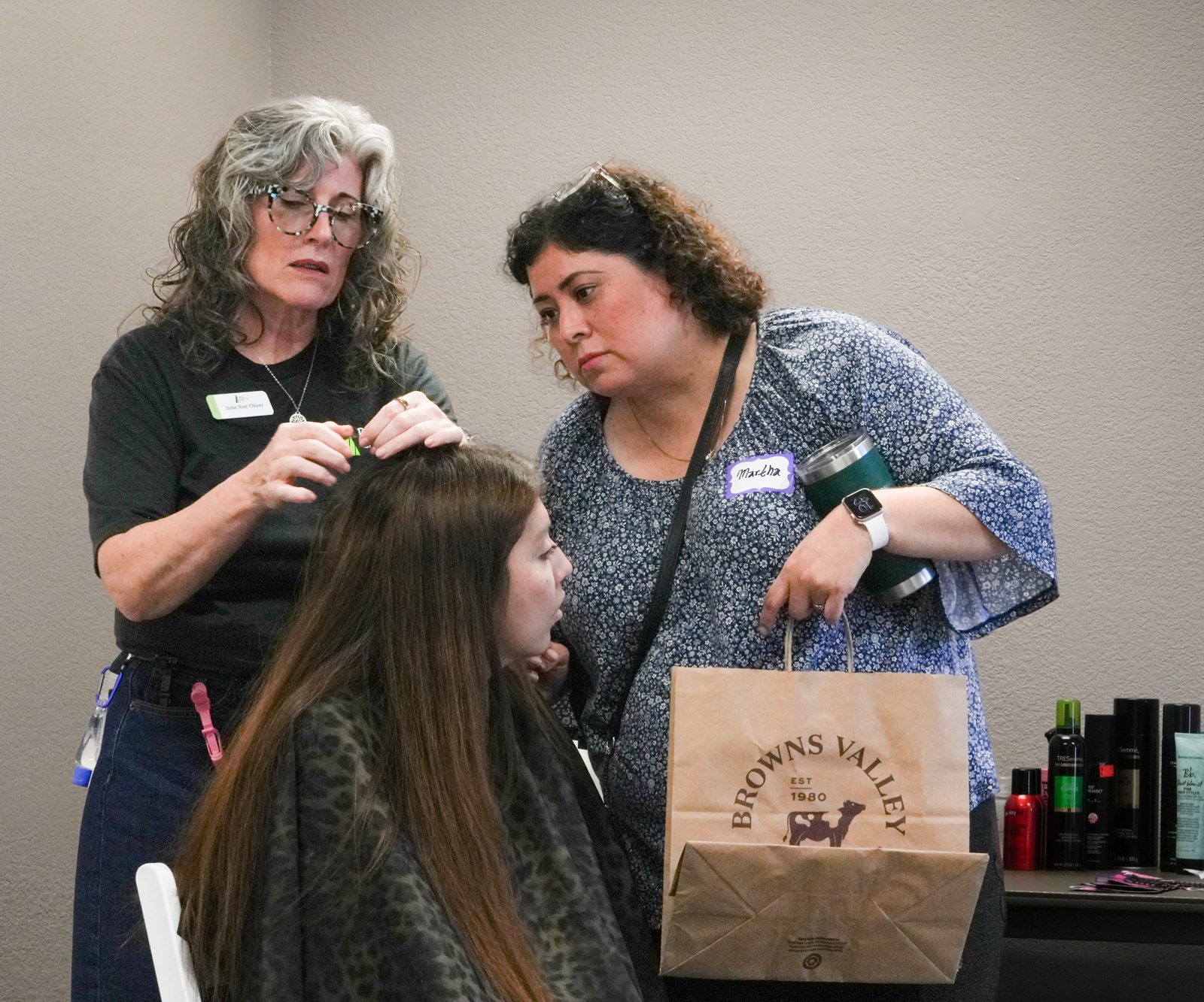Two volunteers styling a guest's hair at Best Foot Forward in Napa