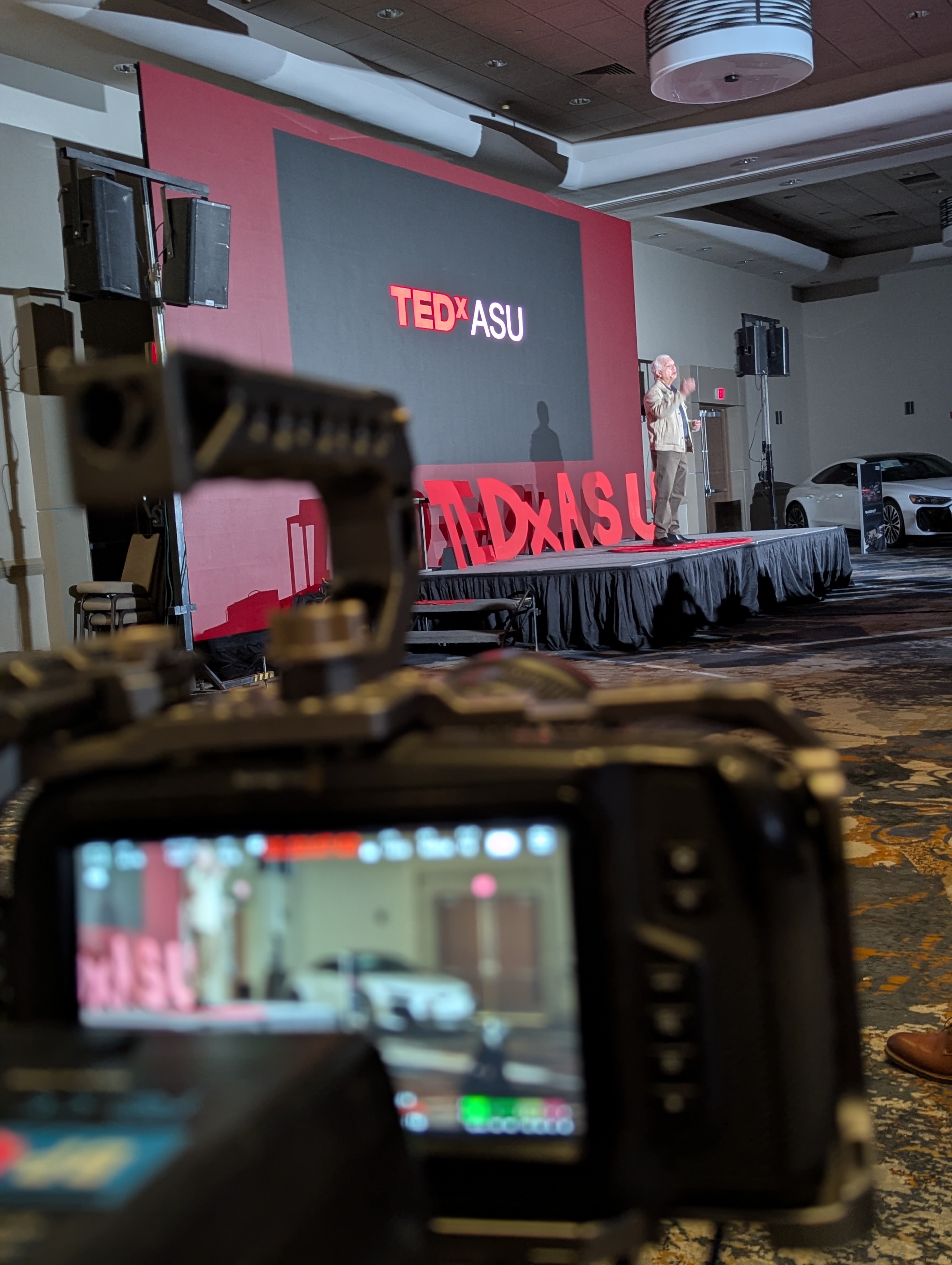 photo of shooting video at ted x with a speaker on stage photo of shooting video at ted x with a speaker on stage