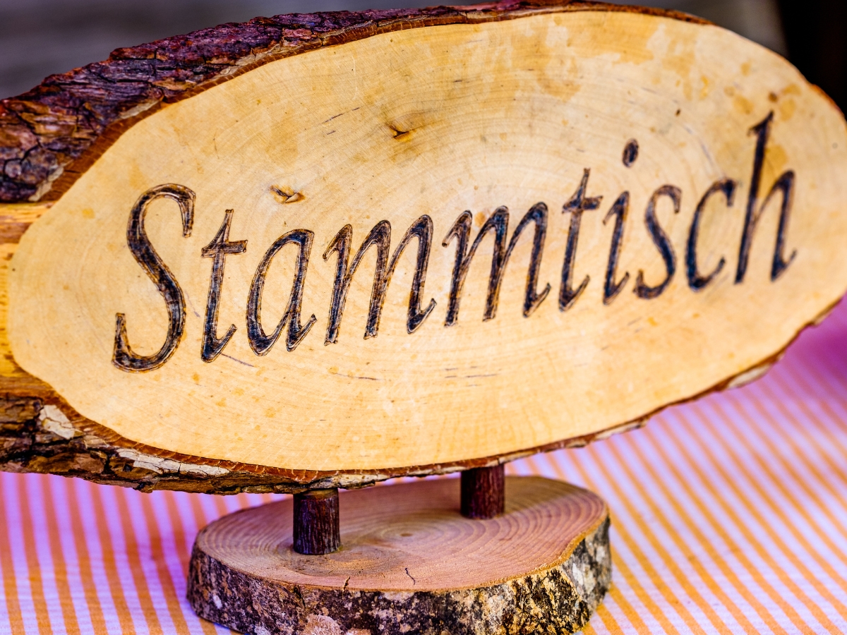 Friends gathered around a table at Zum Treffpunkt for the weekly Stammtisch, sharing food, drinks, and conversation.