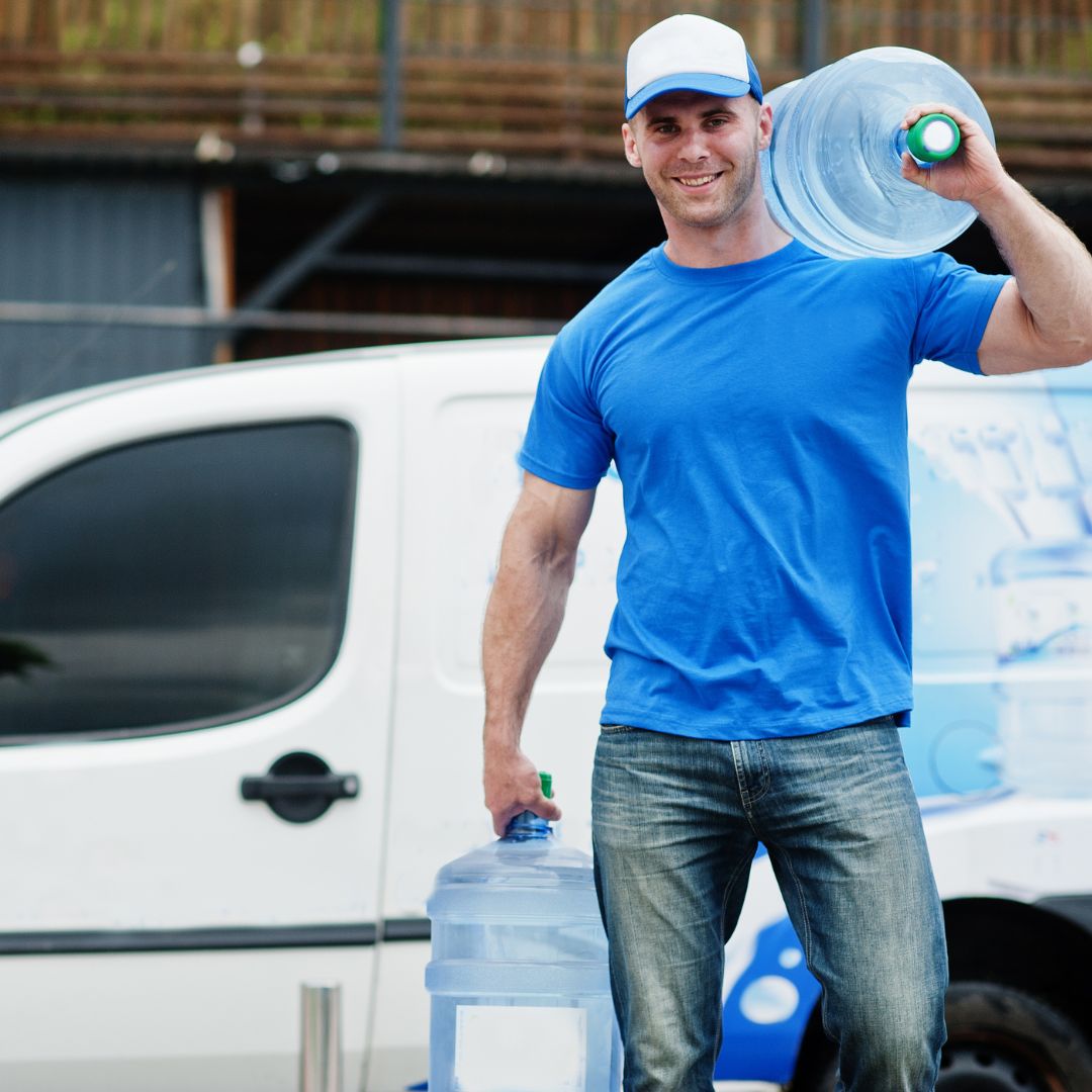 Water delivery professional bringing bottles from a delivery truck