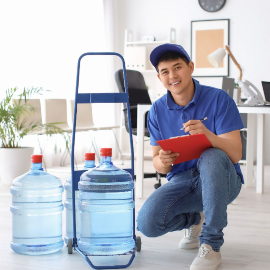Water delivery professional bringing bottles into a home on a dolly