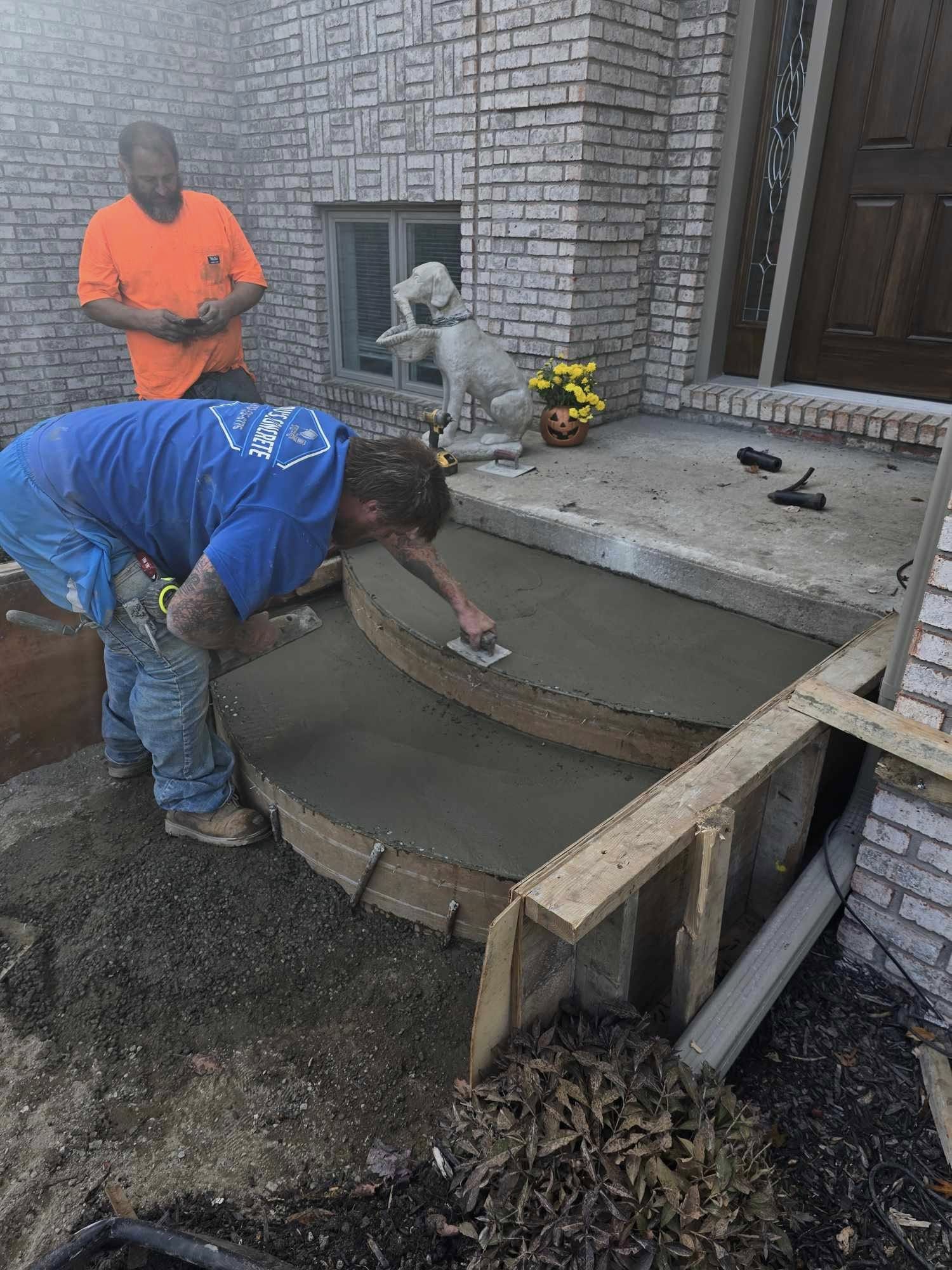 Lou and his team member working on concrete stairs