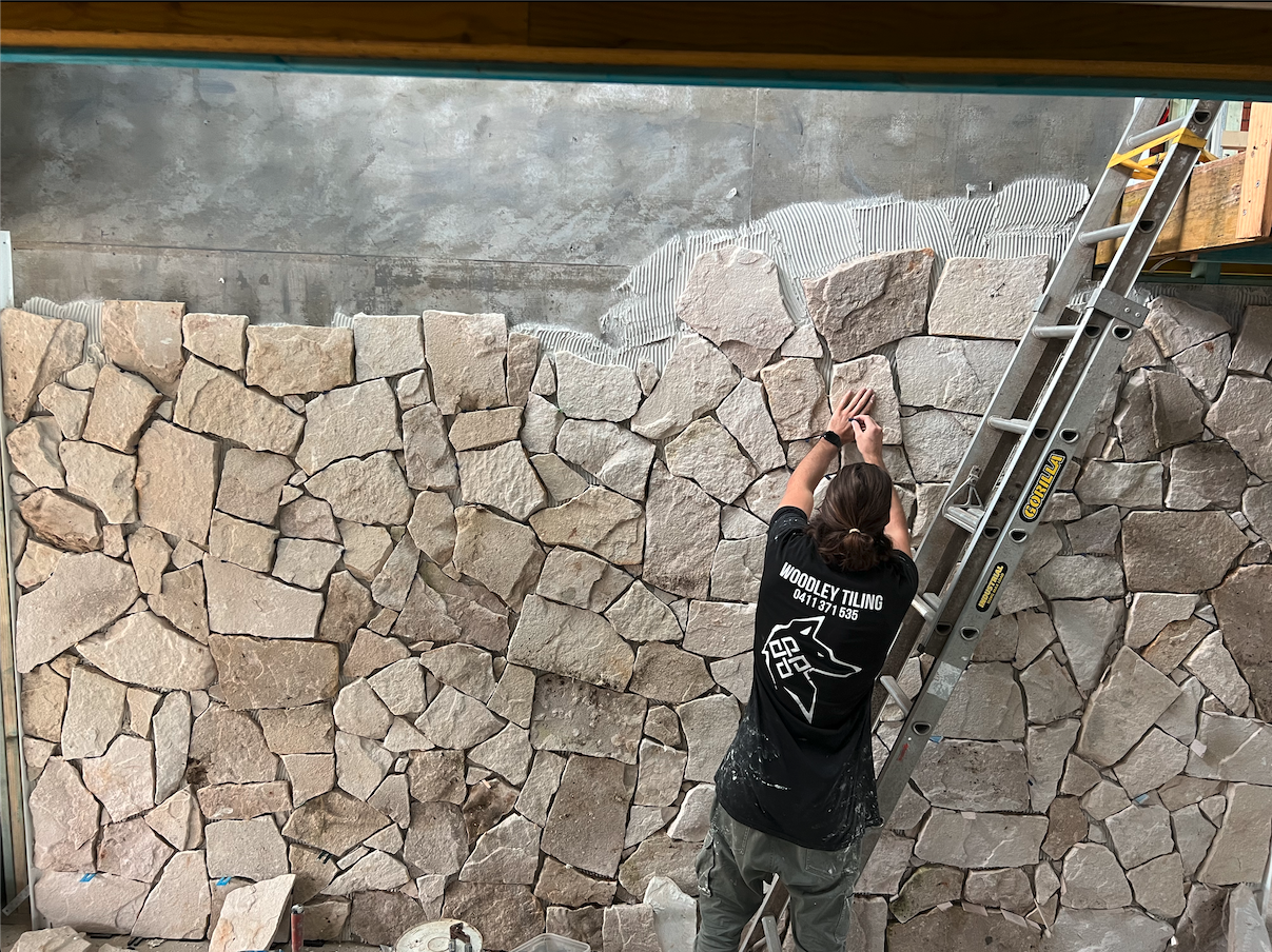 Stone cladding feature wall in progress, staircase — Kiama Downs