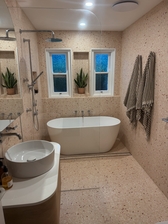 Bathroom with freestanding bath and 20mm pink terrazzo custom shelving — Thirroul