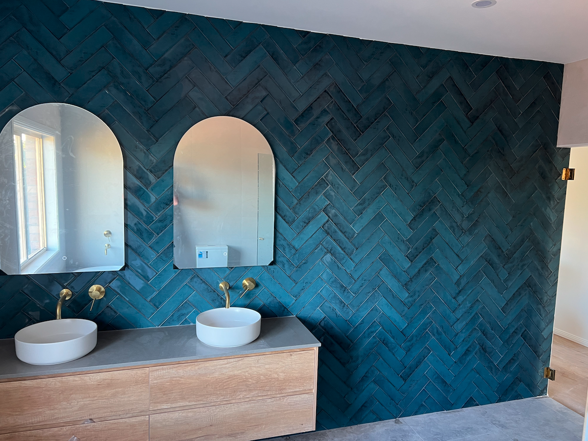 Blue feature wall with double vanity and freestanding bath — Woonona