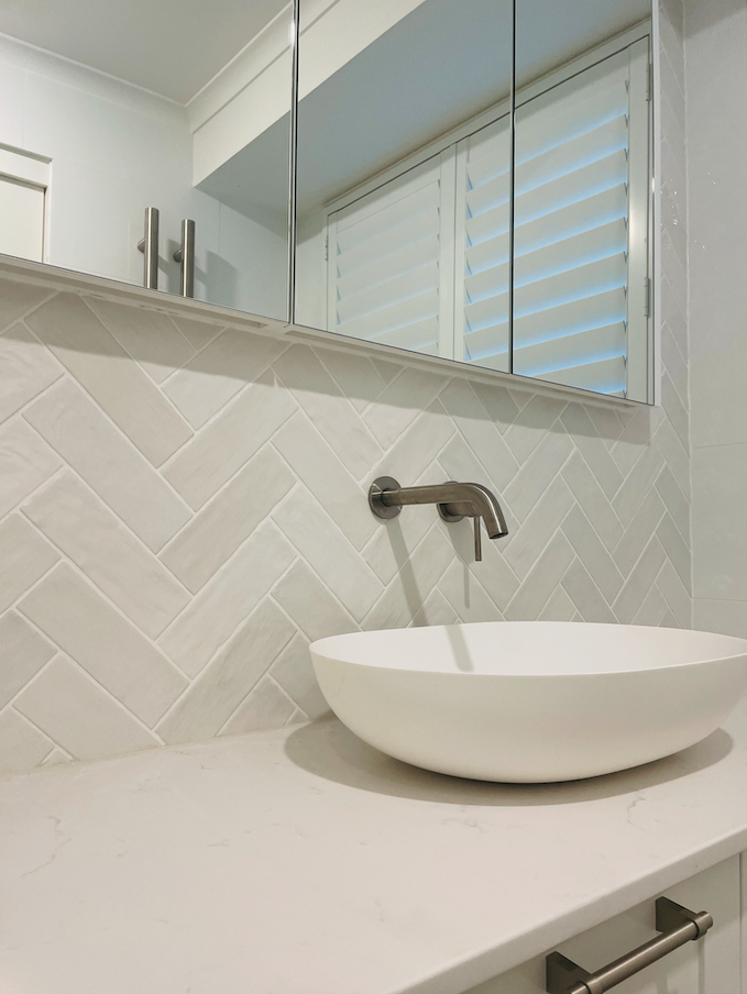 White herringbone ensuite feature wall with vanity and shaving cabinet — Woonona