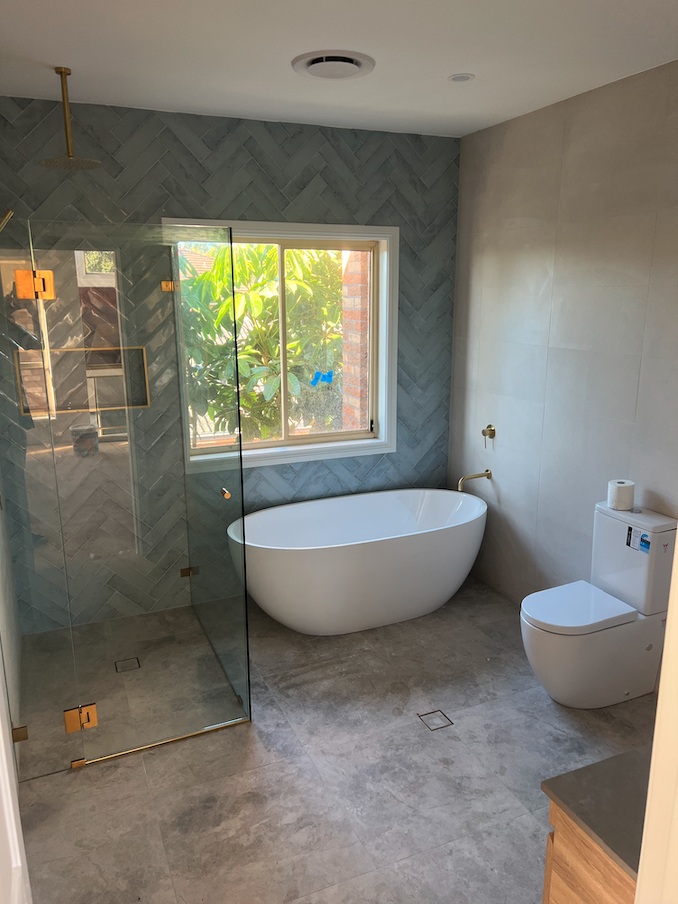 Second bathroom — light blue herringbone shower with freestanding bath — Woonona