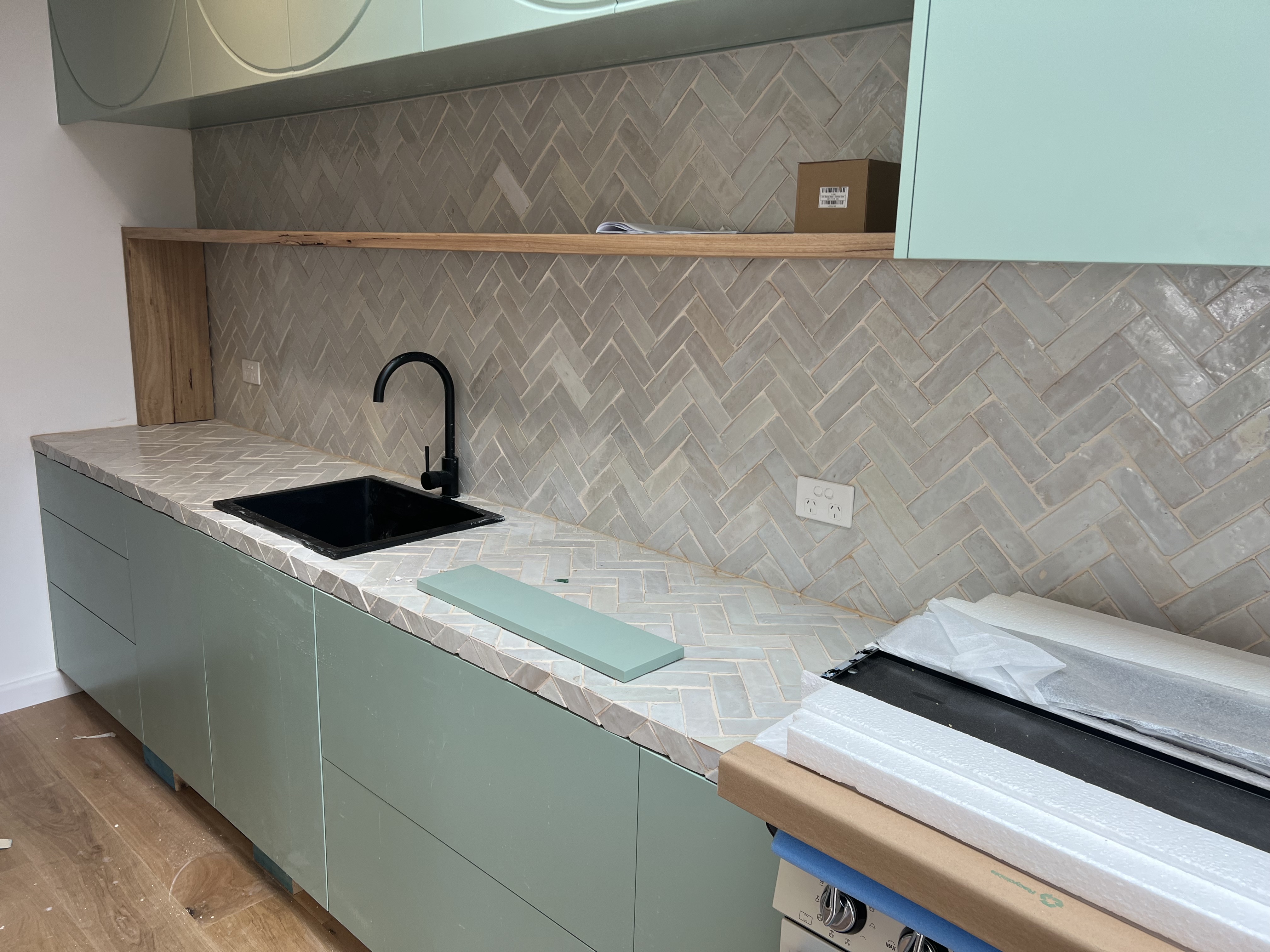Kitchen splashback and benchtop in zellige herringbone — Corrimal