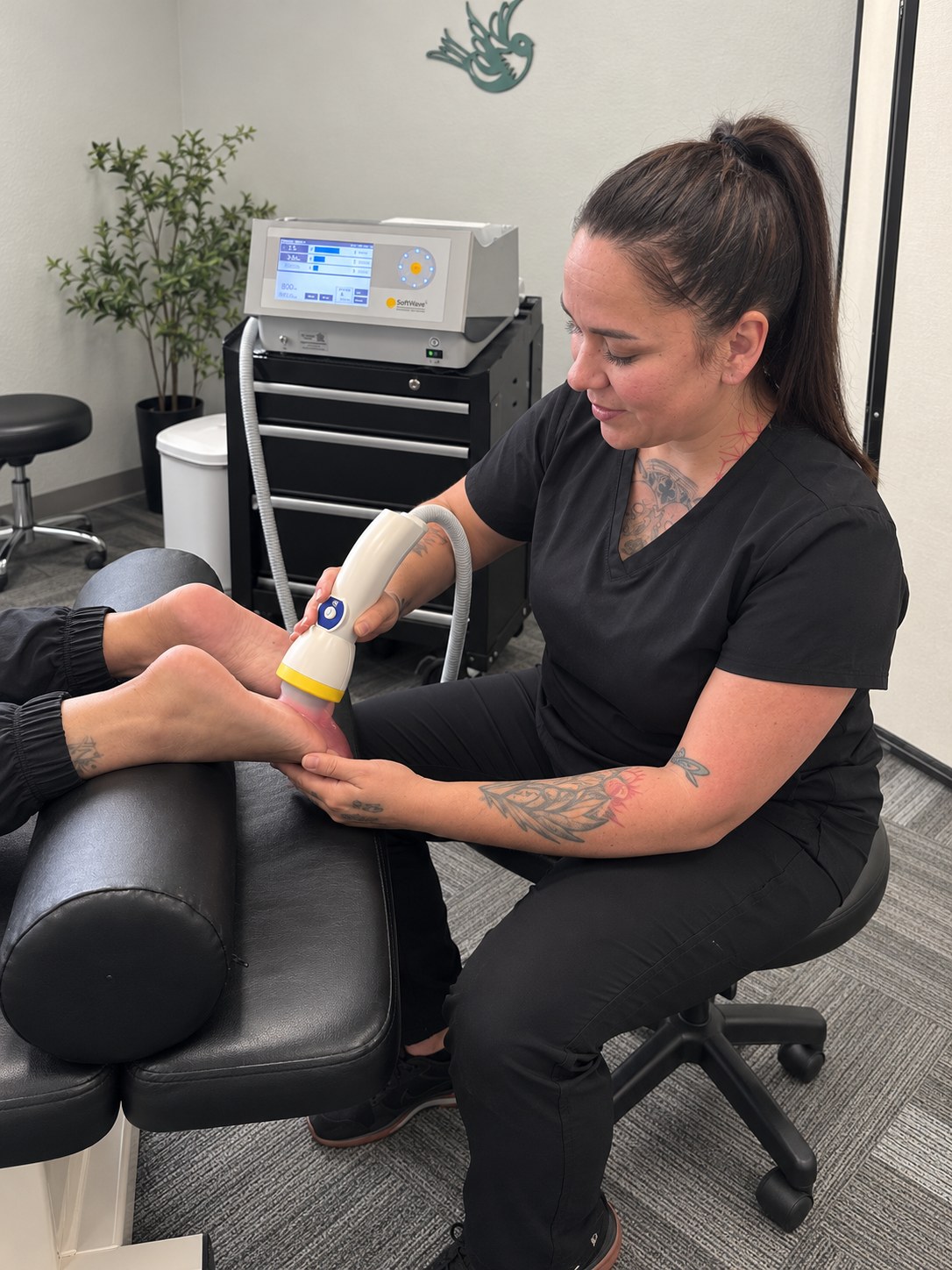 A patient receiving SoftWave shockwave therapy on her heel for plantar fasciitis at Althoff Wellness Clinic in Cheyenne, WY
