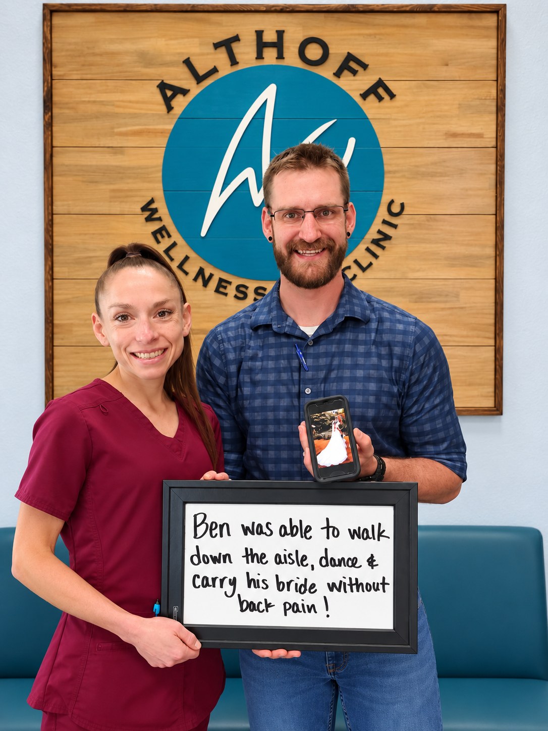Patient Ben holding a whiteboard about walking down the aisle without back pain, with Dr. Jennifer Saboy, DC (Dr. J)