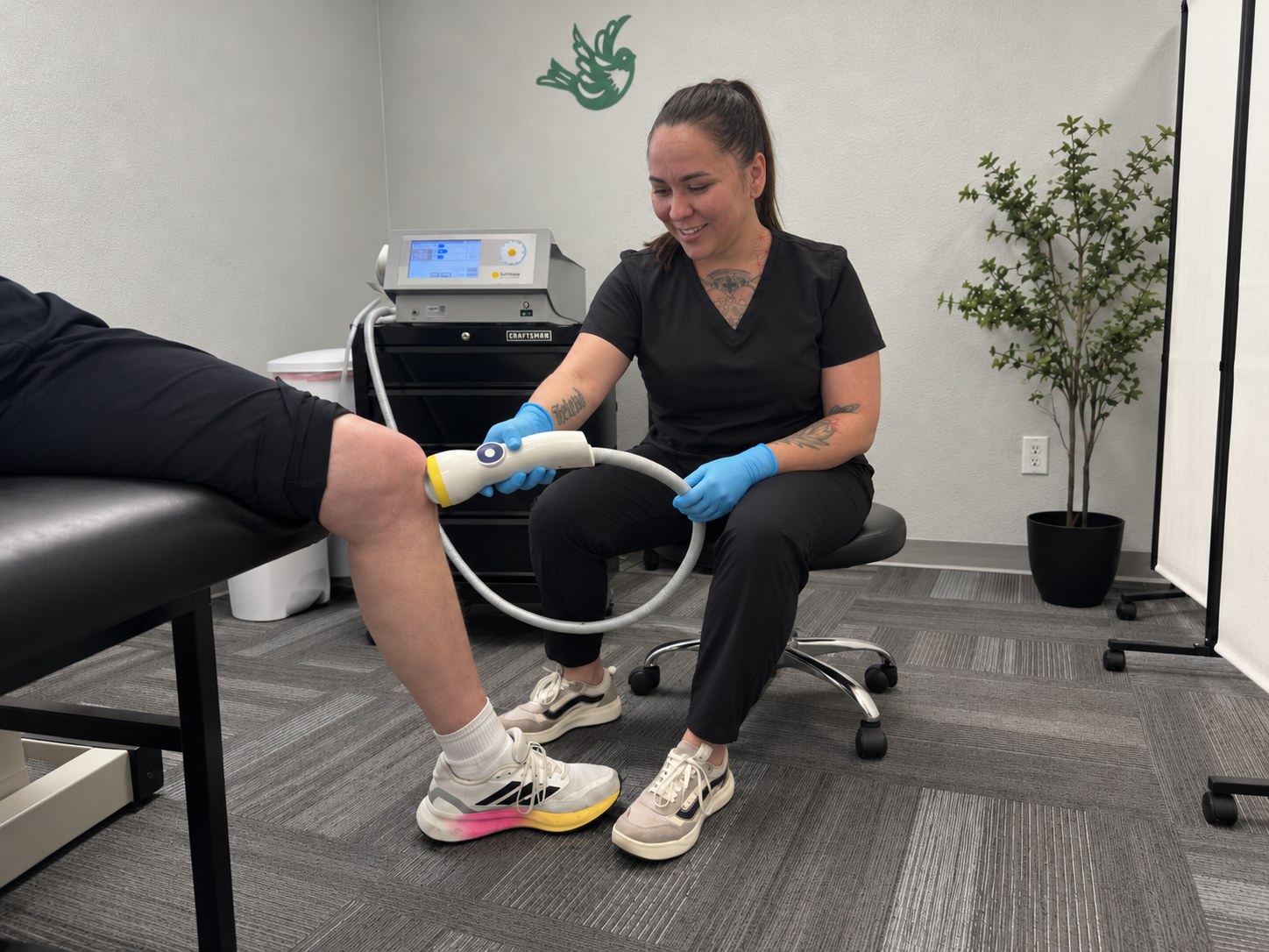 A patient receiving SoftWave shockwave therapy on his knee at Althoff Wellness Clinic in Cheyenne, WY
