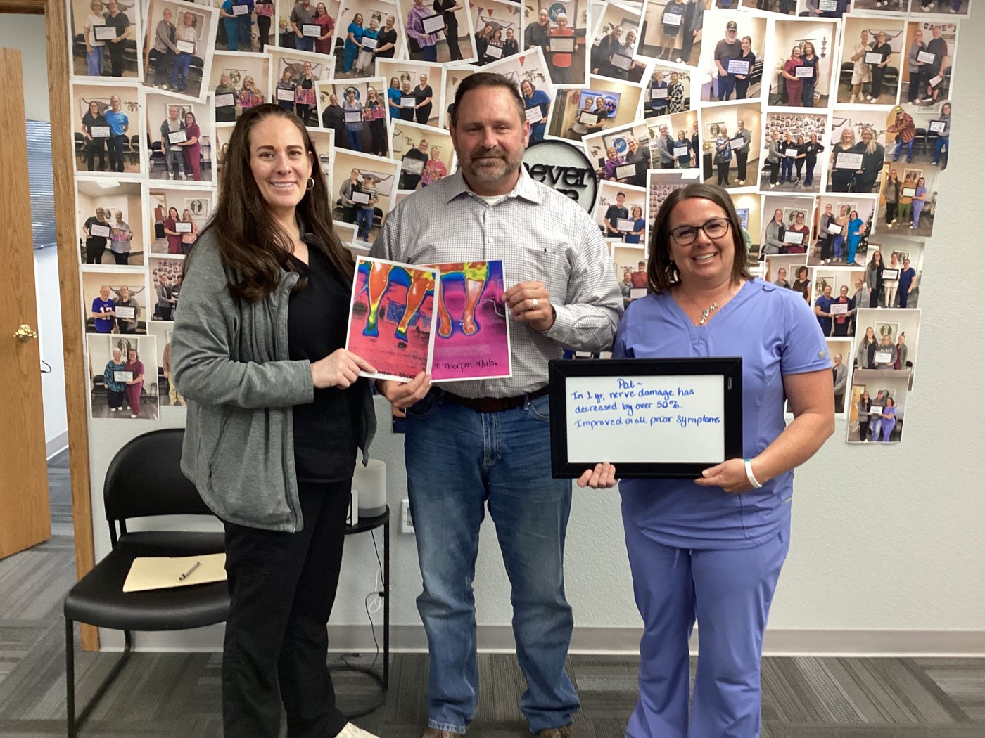 Patient Pat holding a whiteboard about his neuropathy progress with Althoff Wellness Clinic team members in Cheyenne