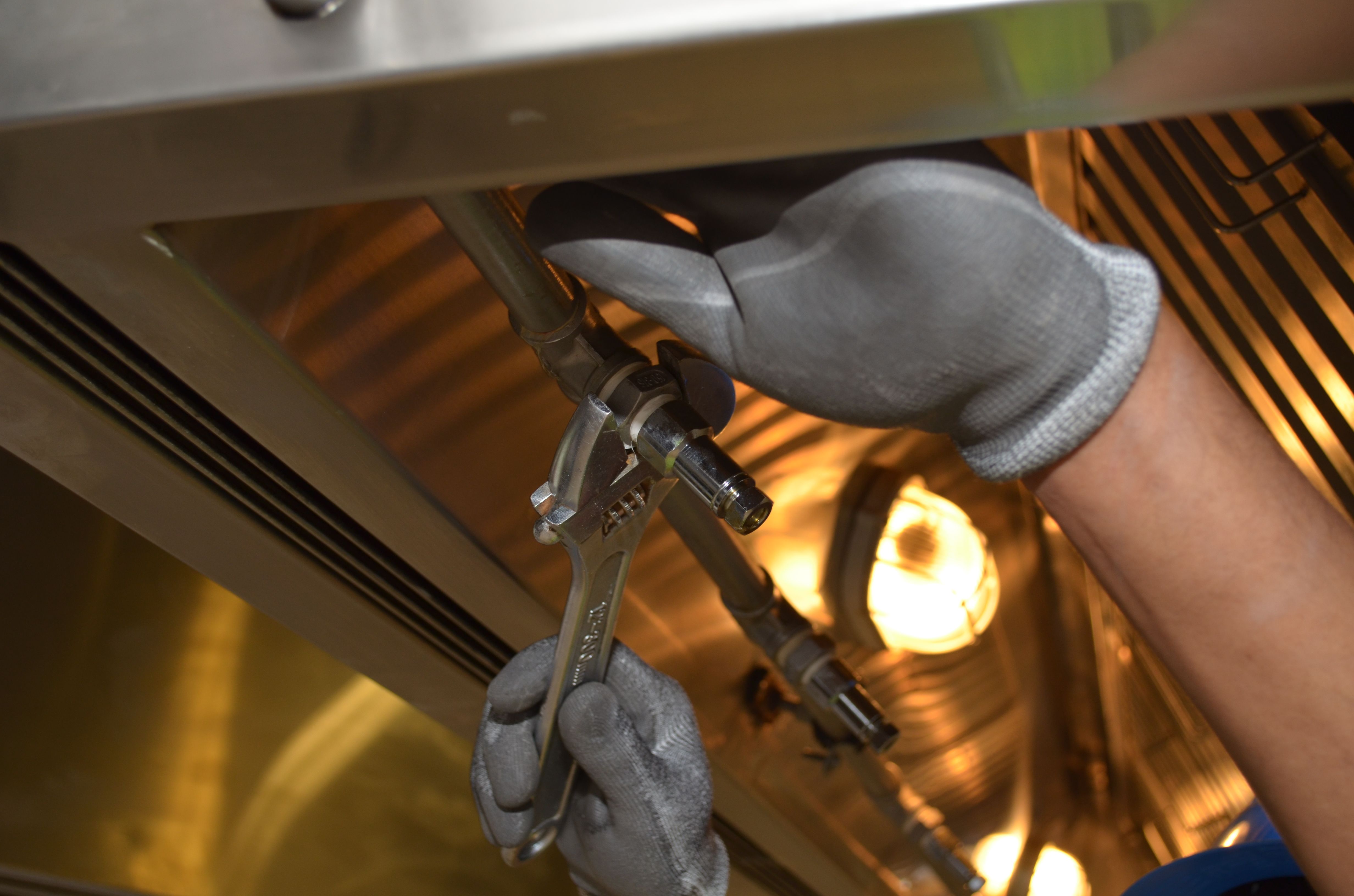 Plumber at work in a kitchen