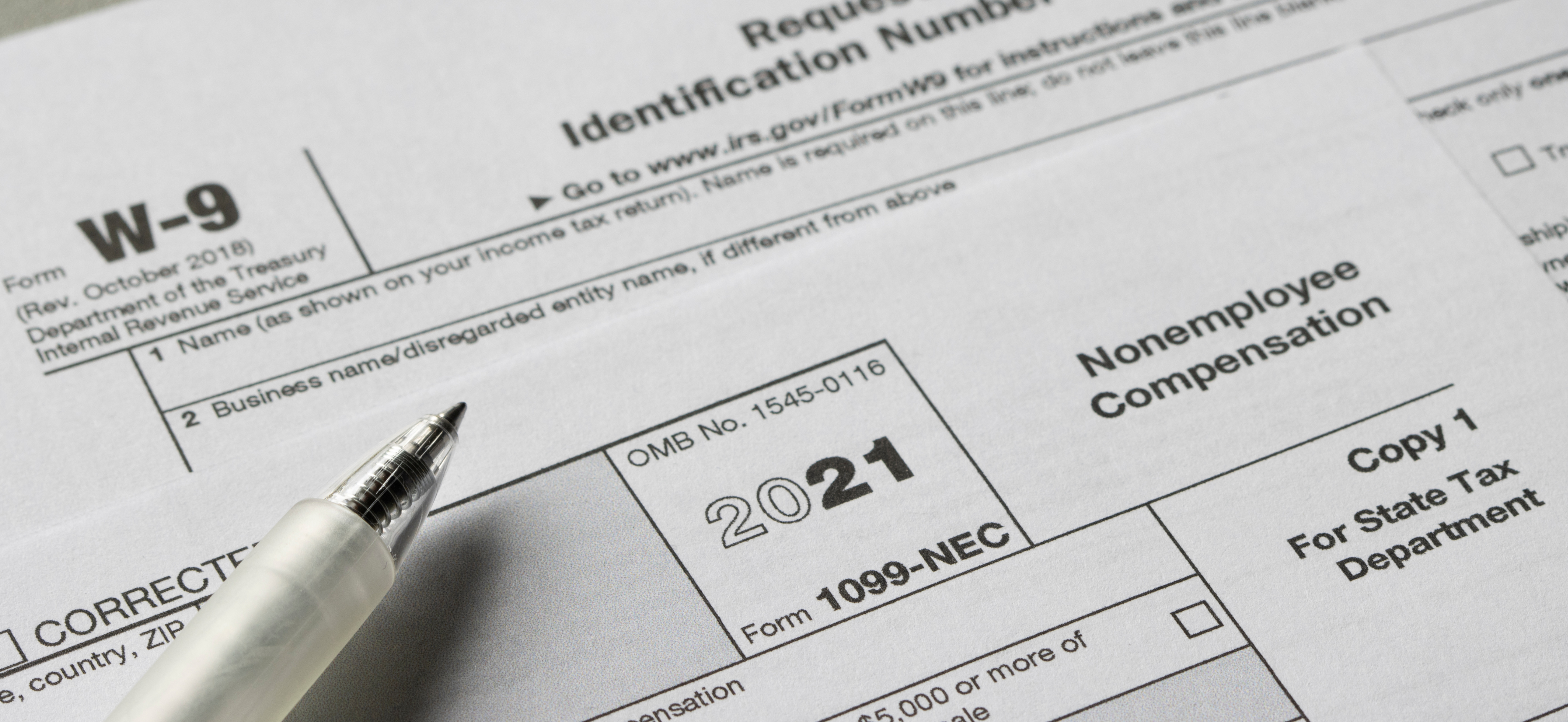 W-9 and 1099-NEC forms with a pen illustrating law firm vendor onboarding, contractor documentation, and clean 1099 compliance processes
